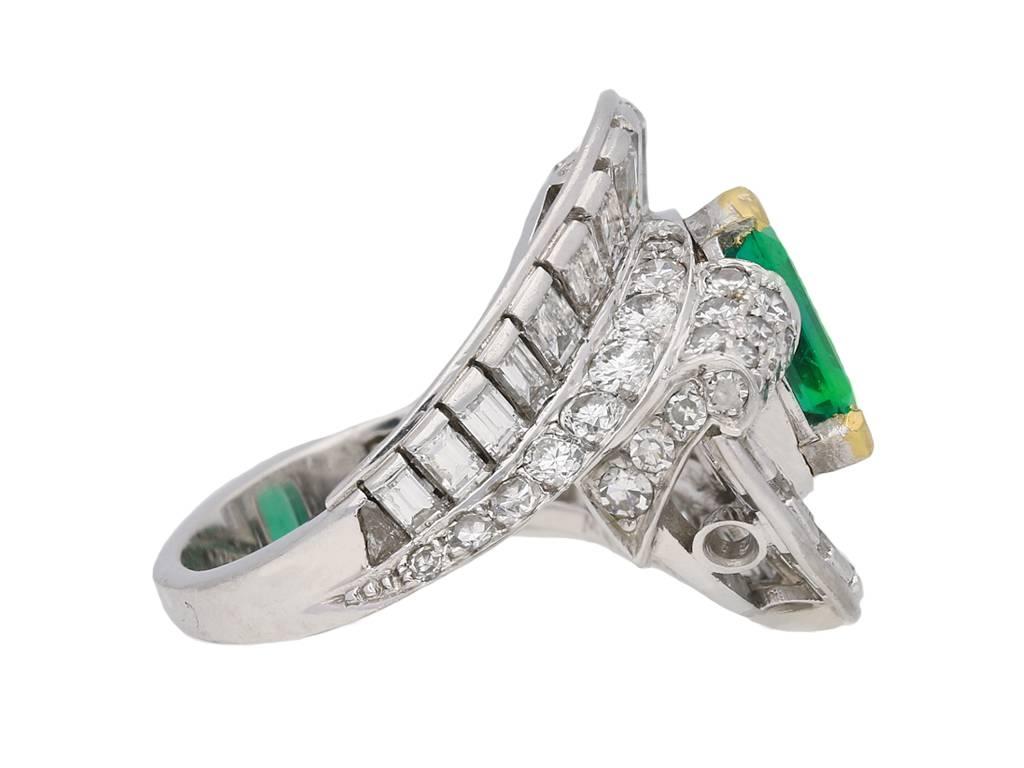 Mellerio Colombian emerald and diamond ring. Set with a central octagonal emerald-cut natural Colombian emerald with no colour enhancement and minor clarity enhancement in an open back yellow gold four claw setting with an approximate weight of 1.40