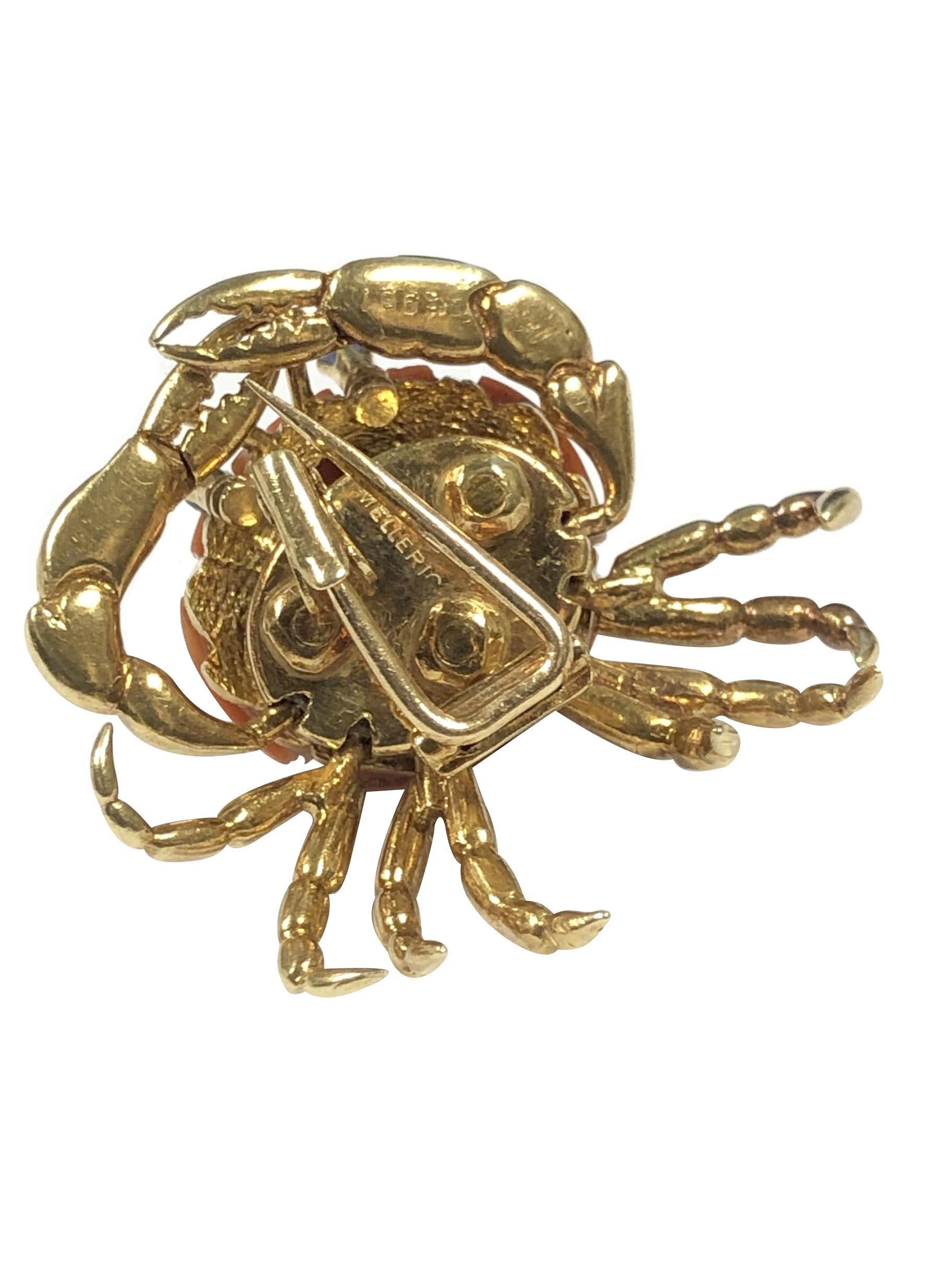 Circa 1970s Mellerio 18K Yellow Gold Crab Brooch, measuring 1 1/2 inch in Diameter and Having Articulated, moving Claws and Legs, centrally set with a 5/8 inch diameter Coral and also having Sapphire Eyes. Having a Double pin, clip fastener.