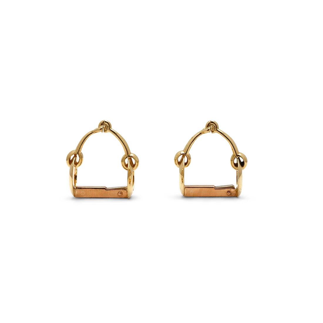 Authentic pair of Mellerio cufflinks crafted in 18 karat yellow gold. These cufflinks feature an equestrian motif - riding bits - and fit around the outside of the shirt cuff. Signed Mellerio and with hallmarks. Cufflinks are presented without the