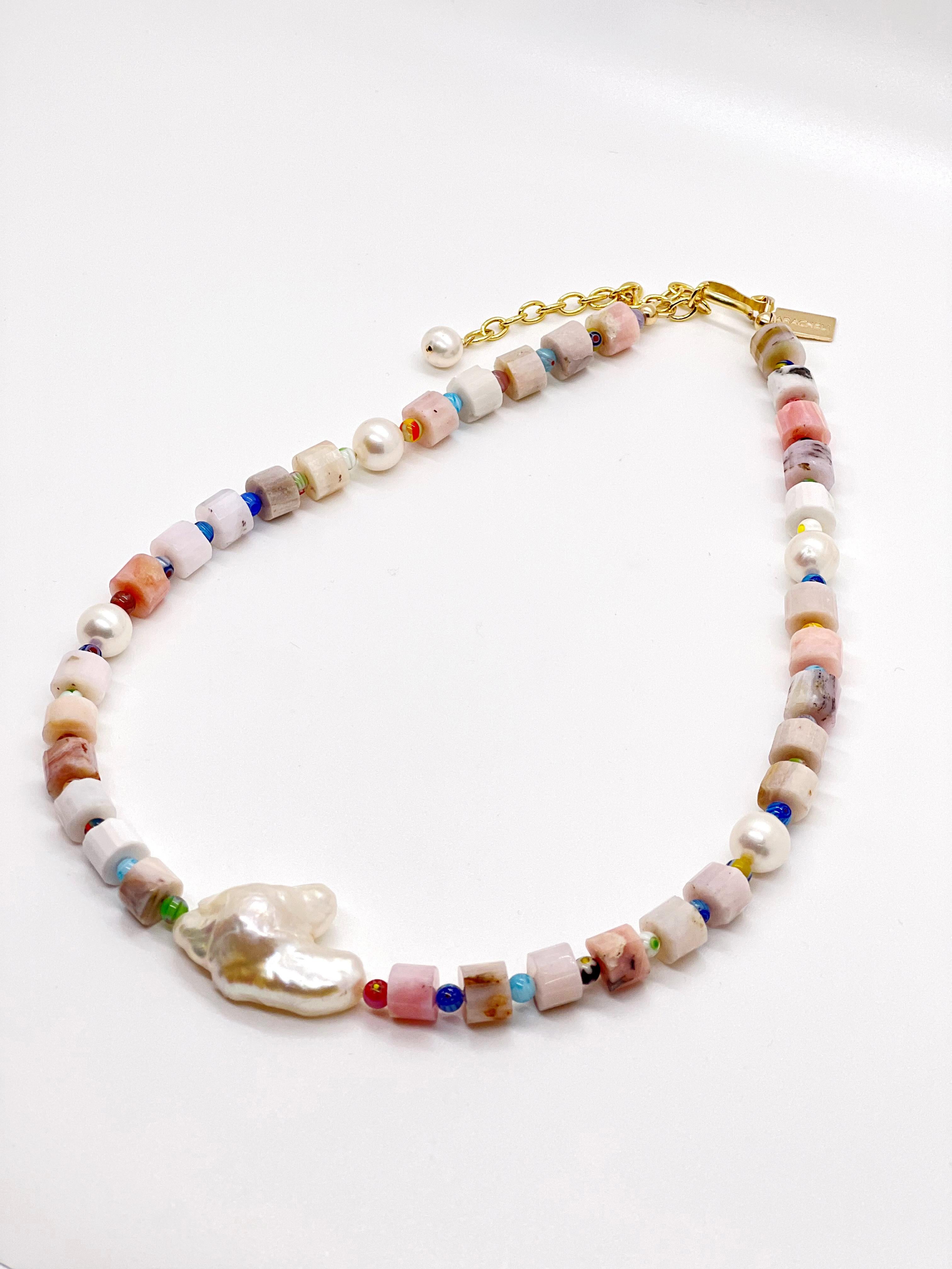 This necklace is composed of pink opal wheel beads that are complimented by vintage Mellifiori beads with a double Biwa freshwater pearl as its center piece. This is such a fun necklace meant to be worn all year round. It is measured at 17 inches