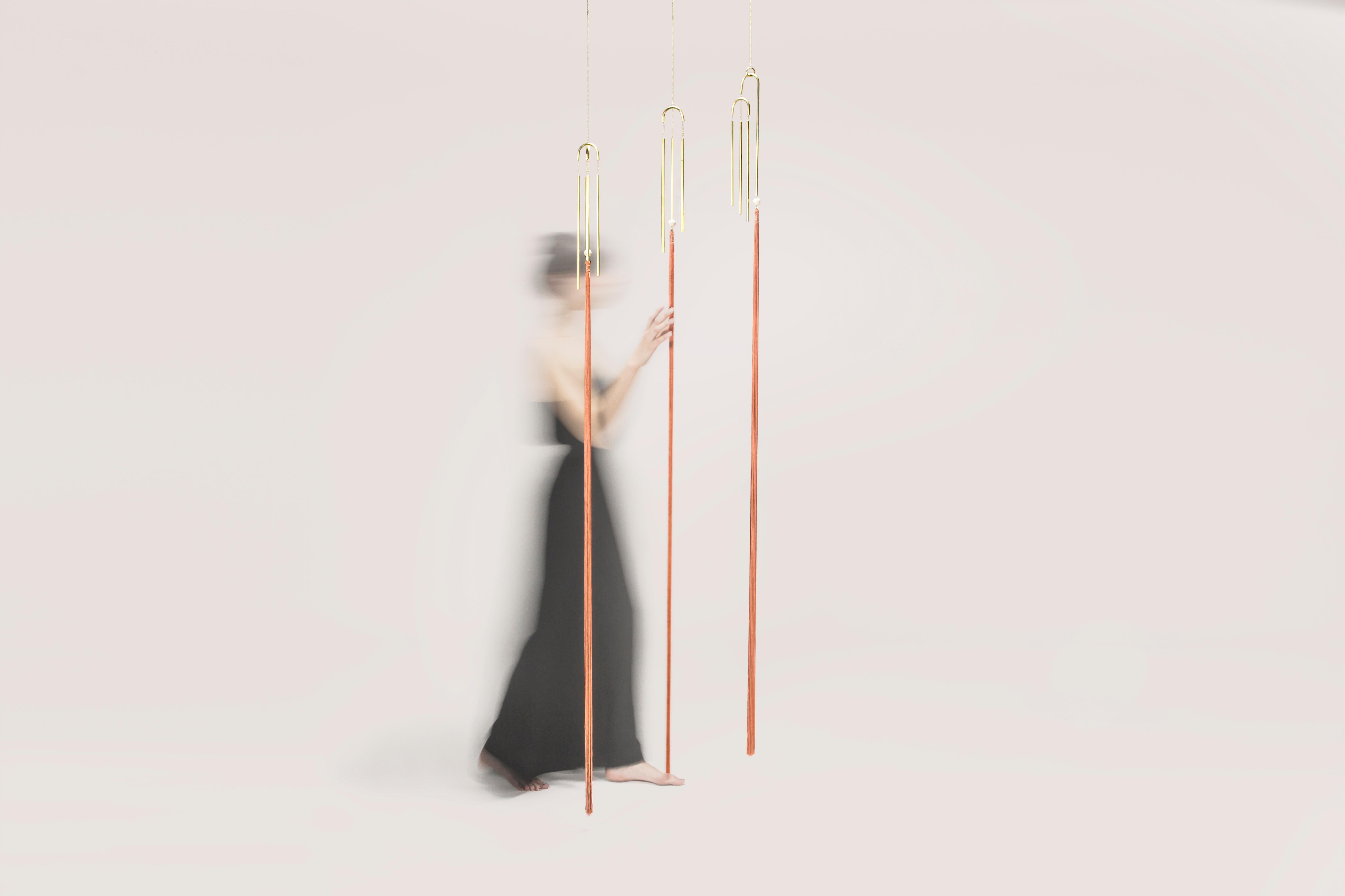 Designed by Agustina Bottoni
Handcrafted in Italy
Materials: solid brass with satin finish, rayon fringes
Size: 150cm x 60cm
Chain length: 150cm / 60

Melodicware explore the auditory experience of objects.

These items contains brass chimes