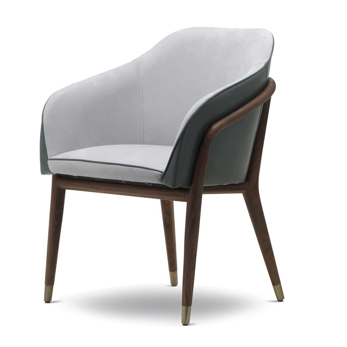 This superb chair is a splendid addition to a modern home, thanks to its exquisite craftsmanship, unique use of colors, and fine materials. The midcentury-inspired design comprises a solid American walnut structure with tapered legs adorned with