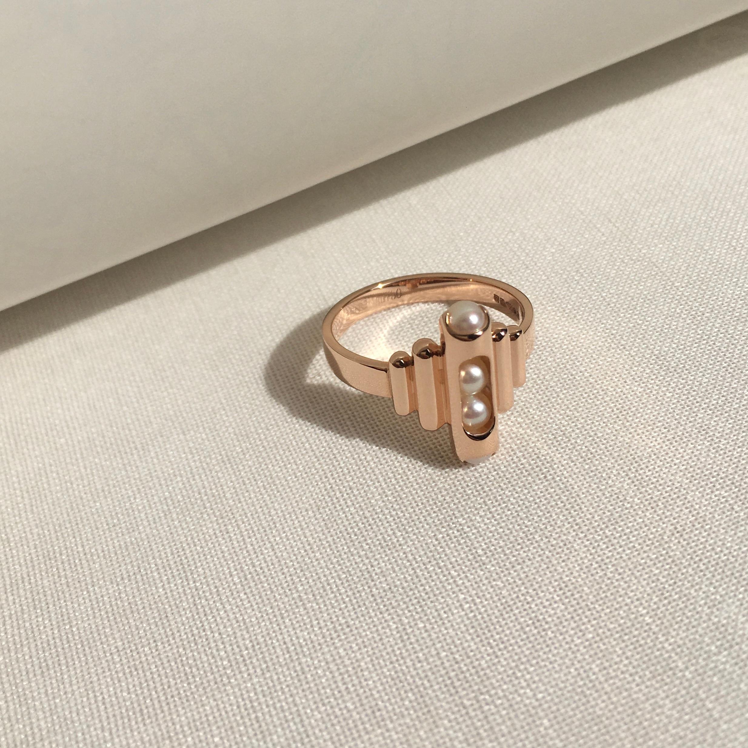 This unique Melody ring combines perfect hand selected Akoya pearls that roll within their 18 karat gold. Gold award winning Melody collection is a clever design solution.  Each piece incorporates a unique movement mechanism so that the gemstones