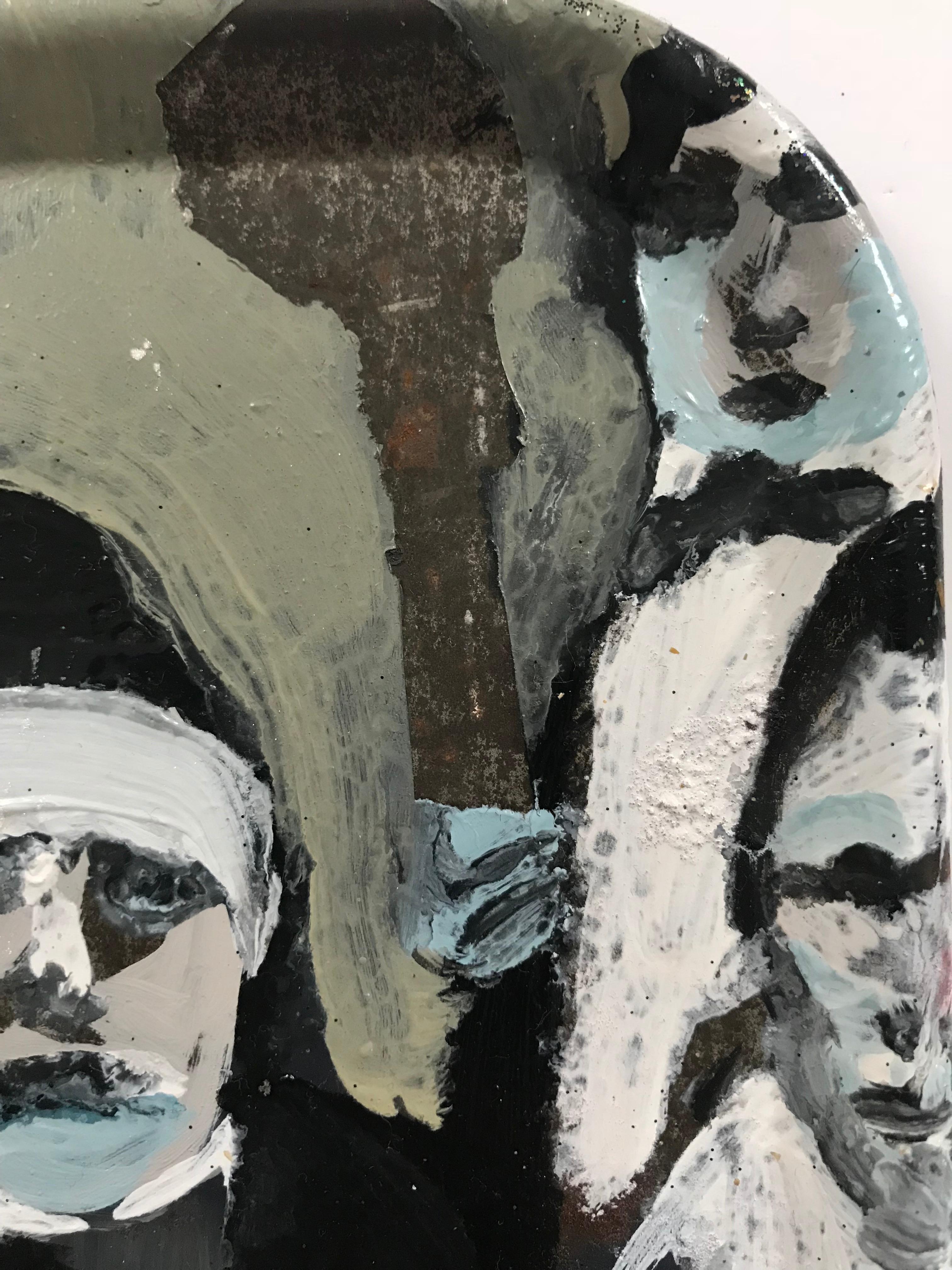 Melora Griffis’ “horn men” is a small 11 x 11 inch oil painting on metal tray of two seated musicians holding trumpets, wearing black bowties, white shirt fronts and black dinner jackets.  Three further musicians are visible, but painted around the