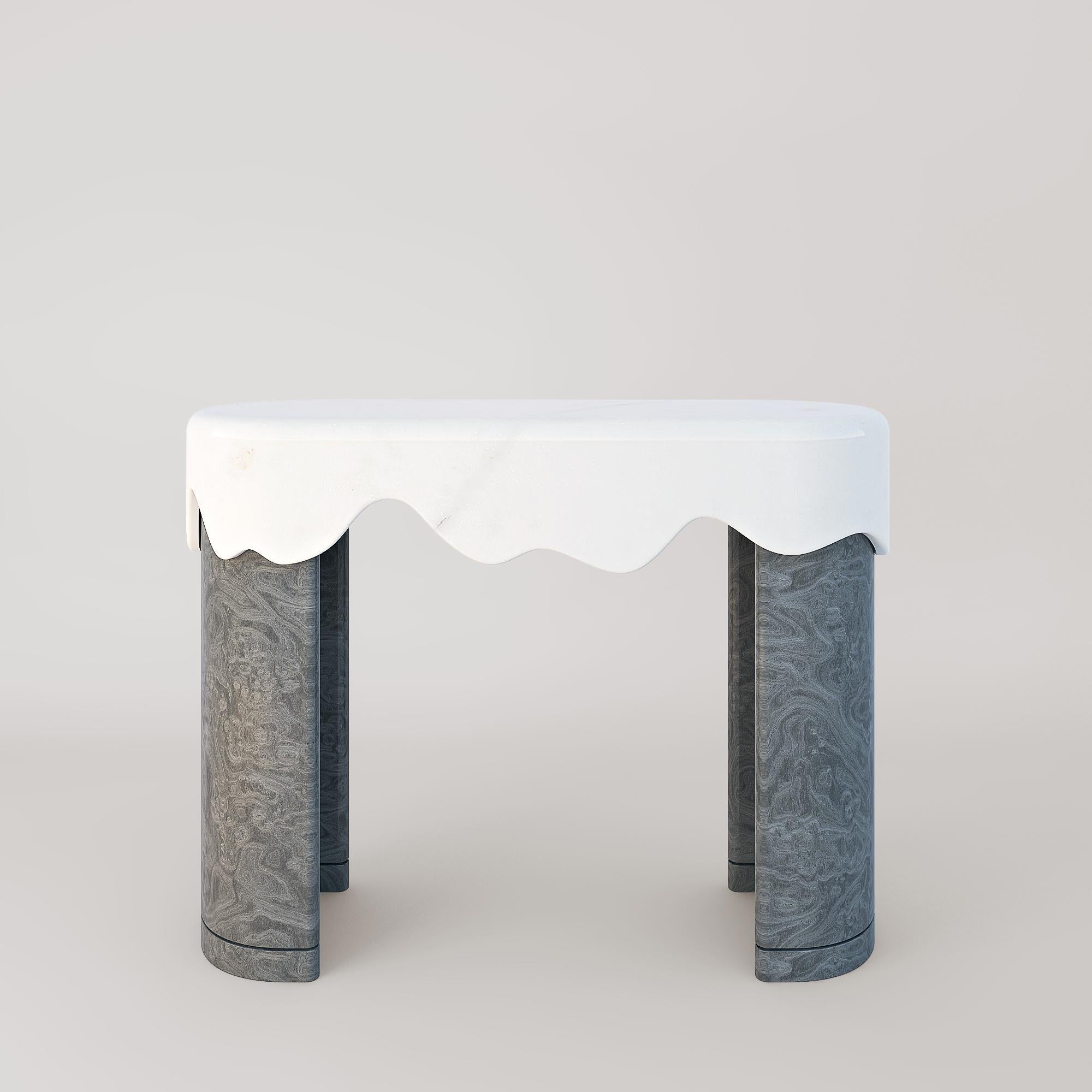 Blurring the lines between solidity and fluidity, the Melt collection leans on natural stones and wood to form a three-piece collection of tables while each piece plays with complementing and contrasting these materials in the name of achieving