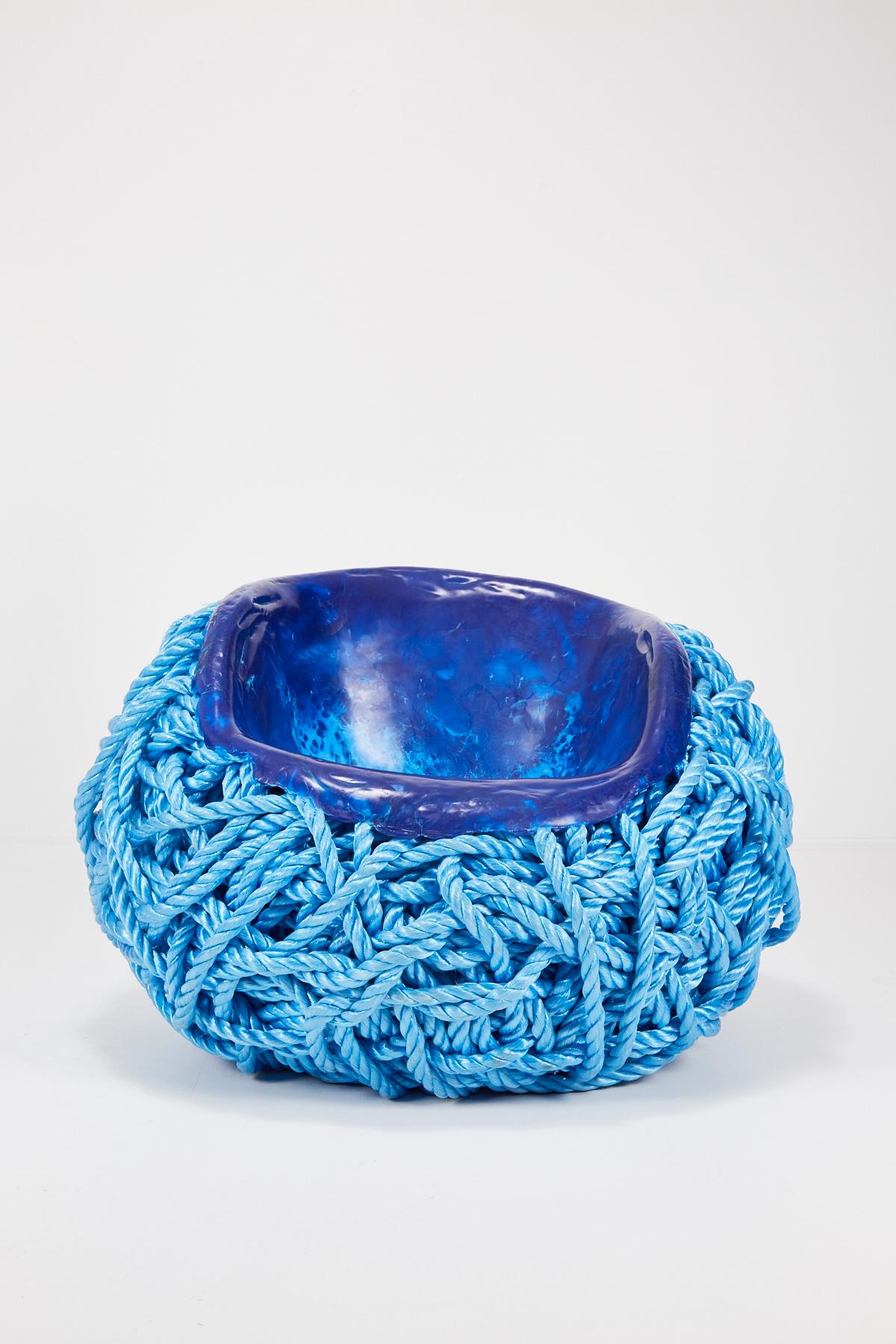 Meltdown chair: PP rope blue is created by heating and pressing a seat-shaped former into a ball of polypropylene rope (or nautical rope as used on boats). The rope begins to liquefy as it comes into contact with the heated former and, as it cools,