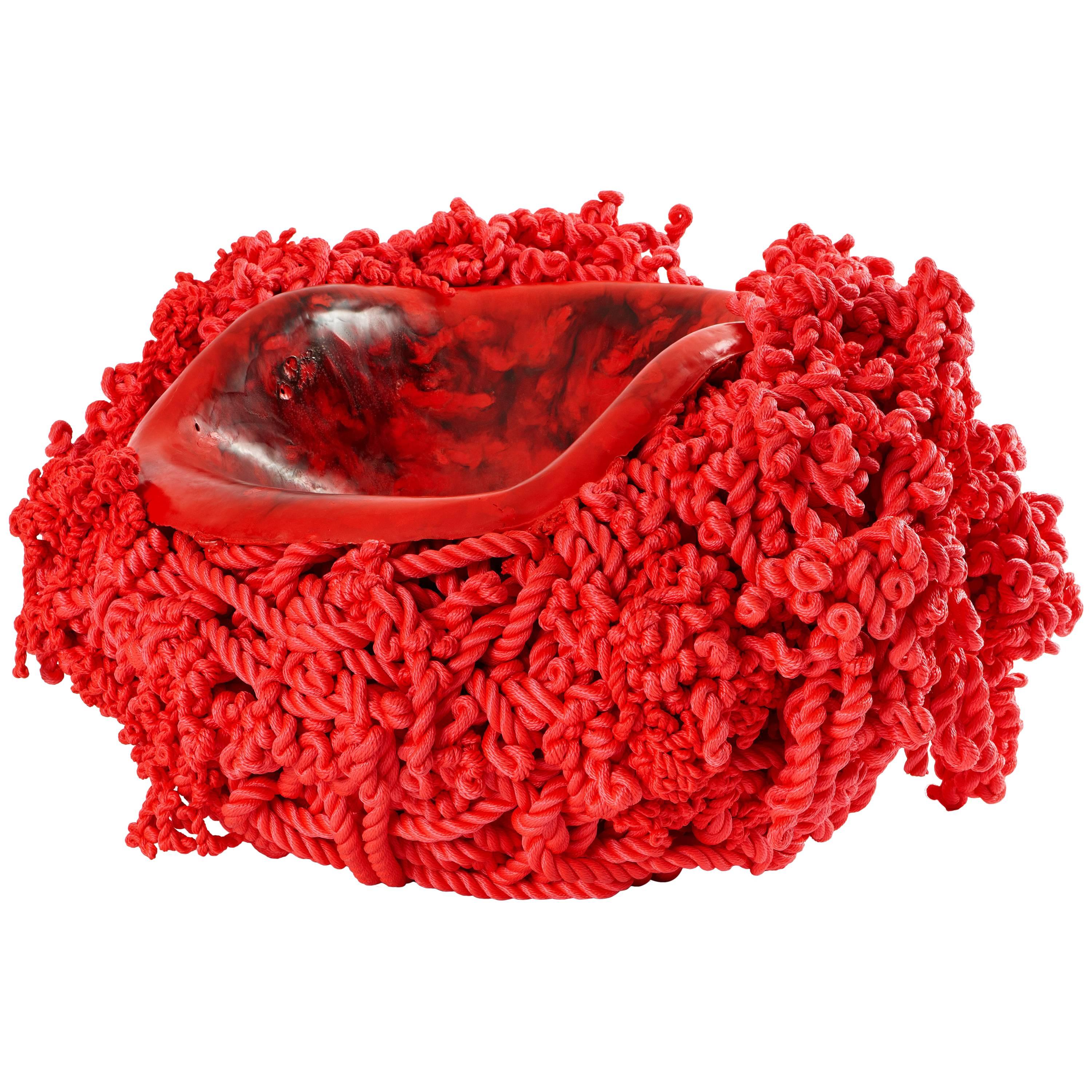 Meltdown chair: PP rope red is created by heating and pressing a seat-shaped former into a ball of polypropylene rope (or nautical rope as used on boats). The rope begins to liquefy as it comes into contact with the heated former and, as it cools,