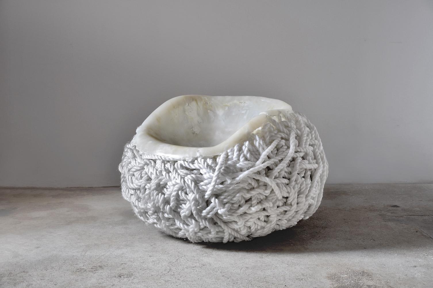 'Meltdown Chair, White Rope' is a piece by English artist Tom Price, from the Meltdown Series. This chair is made entirely from polypropylene rope, no other material is added. The artist starts its creation by rolling up the rope around a ball –
