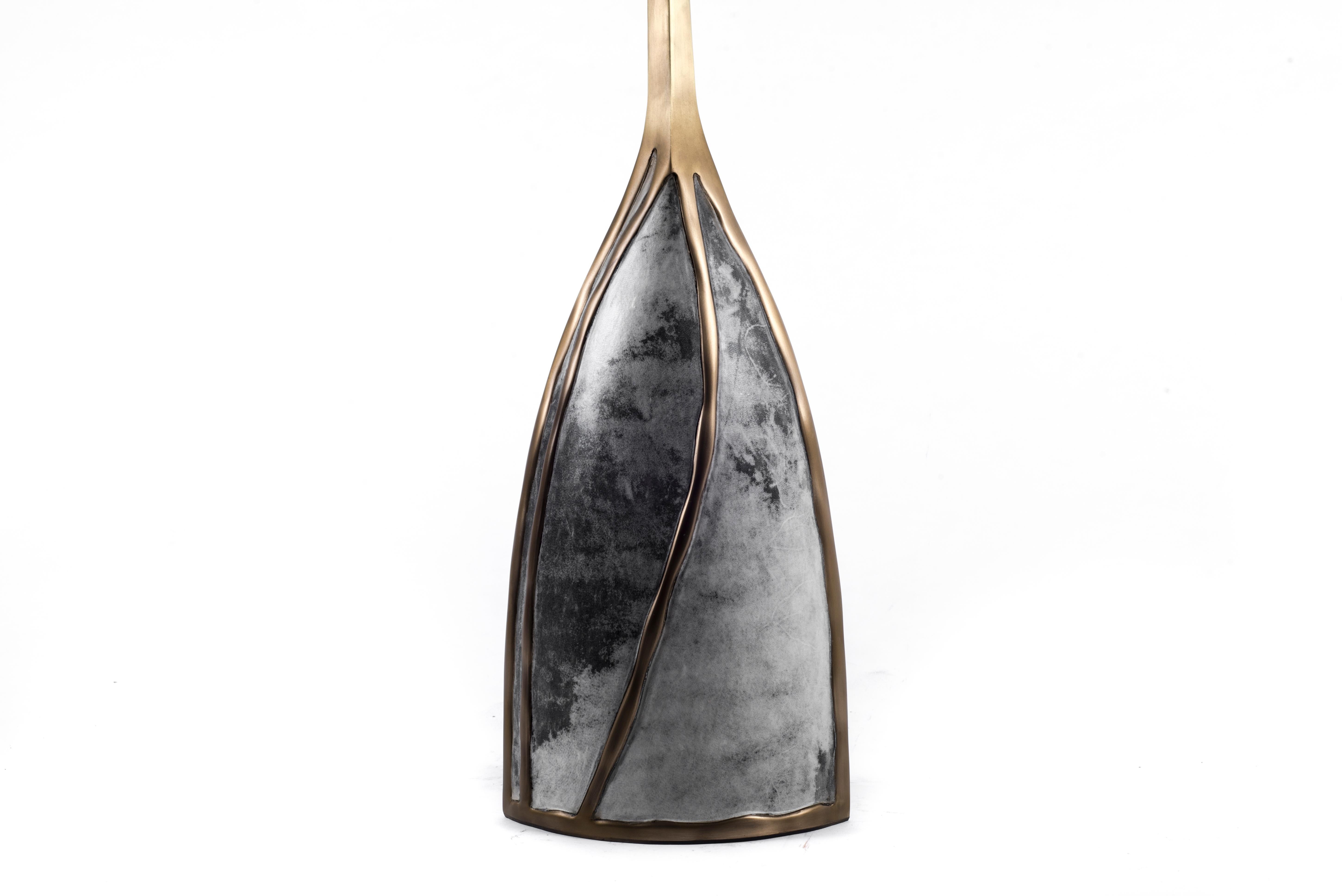 The melting candle base by Patrick Coard is a bold sculptural piece for any space. The intricate uneven surfaced bronze-patina brass structure creates the melting effect, mixed with a smokey dyed parchment inlay. Exotic-textured mineral wax candles