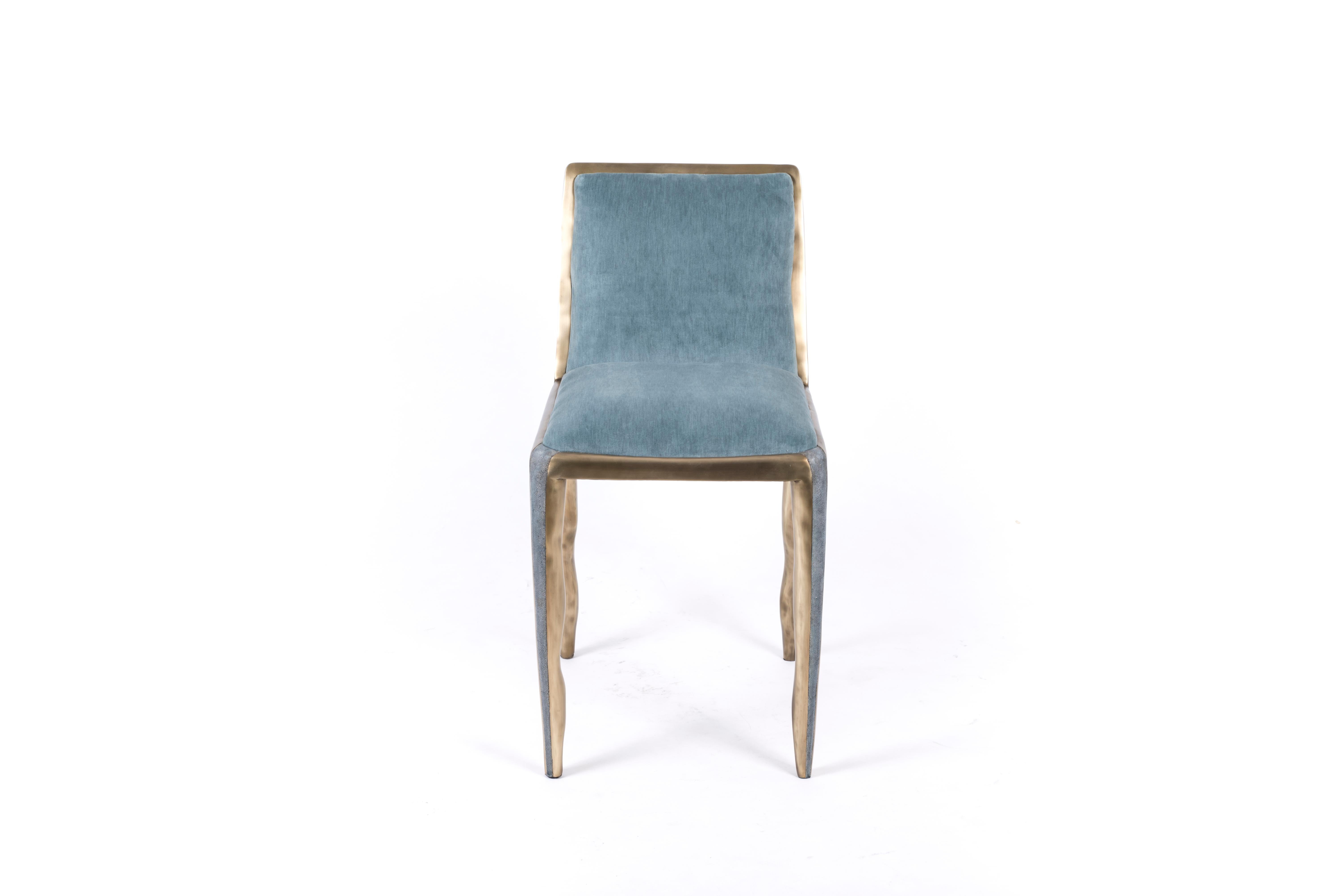 The melting chair in blue shagreen and bronze patina brass is a beautiful piece to accompany a dining table or desk. The piece has incredible detail and inlay work with the shagreen running down the center of the legs, surrounded by the irregular