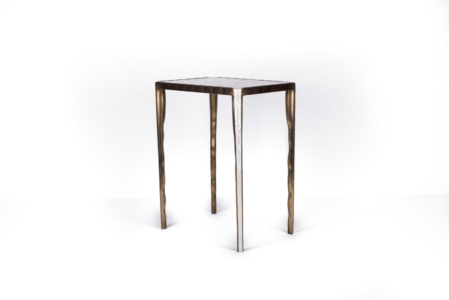 The melting nesting side table in medium is part of a series of nesting side tables (sold separately). One can purchase the tables on their own or buy them as a set to create elegant and geometric shapes. This piece is inlaid in mother of pearl and