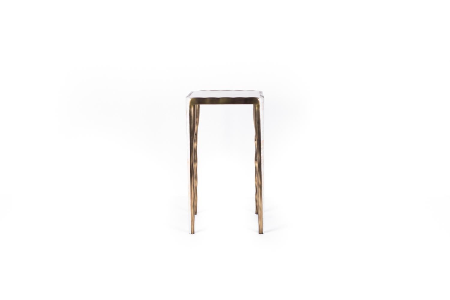 The Melting Nesting Side Table in Small is part of a series of nesting side tables (sold separately) . One can purchase the tables on their own or buy them as a set to create elegant & geometric shapes. This piece is inlaid in mother of pearl and