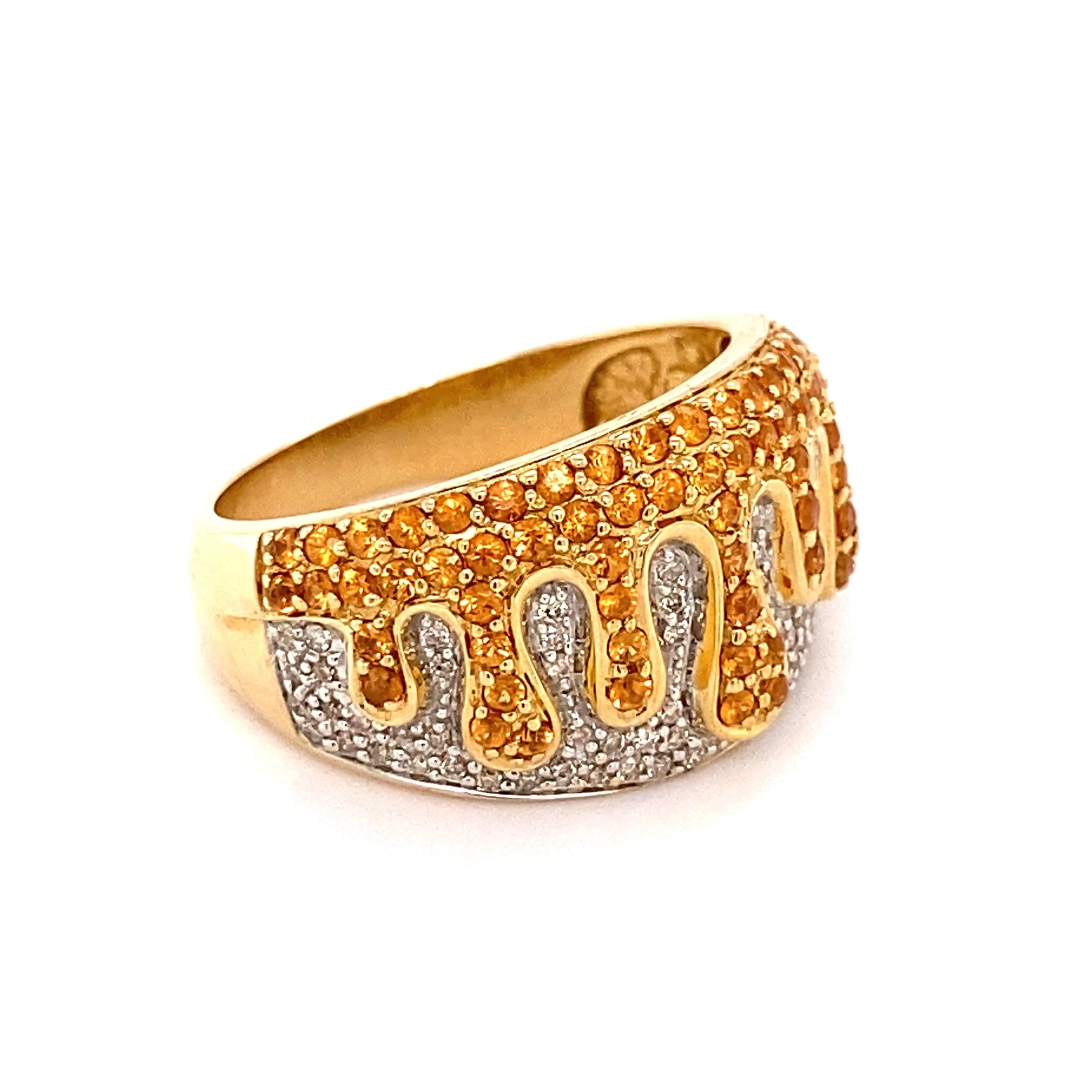 Simply Beautiful! Diamond and Melting Orange Zircon Cocktail Band Ring. Securely Hand set with Melting Orange Zircon approx. 1.50tcw over Round Brilliant-Cut Diamonds weighing approx. 0.60tcw. Hand crafted 14K Yellow Gold mounting. Measuring approx.