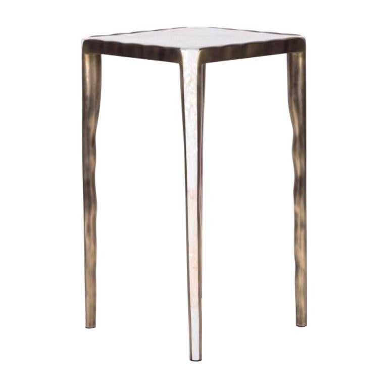 The melting nesting side table in small is part of a series of nesting side tables (sold separately). One can purchase the tables on their own or buy them as a set to create elegant & geometric shapes. This piece is inlaid in cream shagreen and the