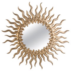 Miroir en forme de soleil couchant avec peinture dorée