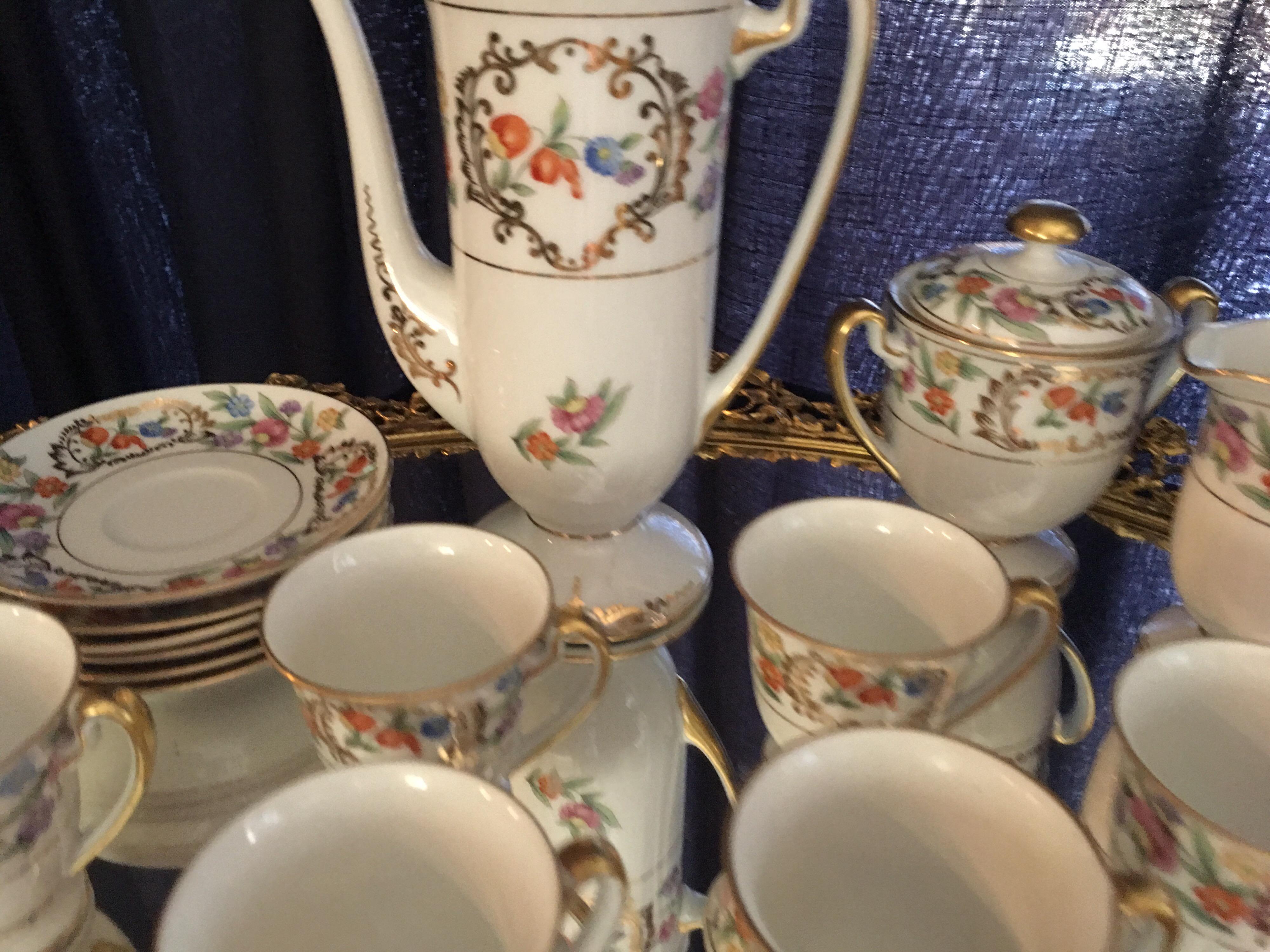 This lovely vintage floral china tea service was purchased in the 1960s by a couple on their honeymoon in Panama. It has always resided on a vintage mirror and brass floral tray that accompanies the tea set. Most Melton China was made in the UK but