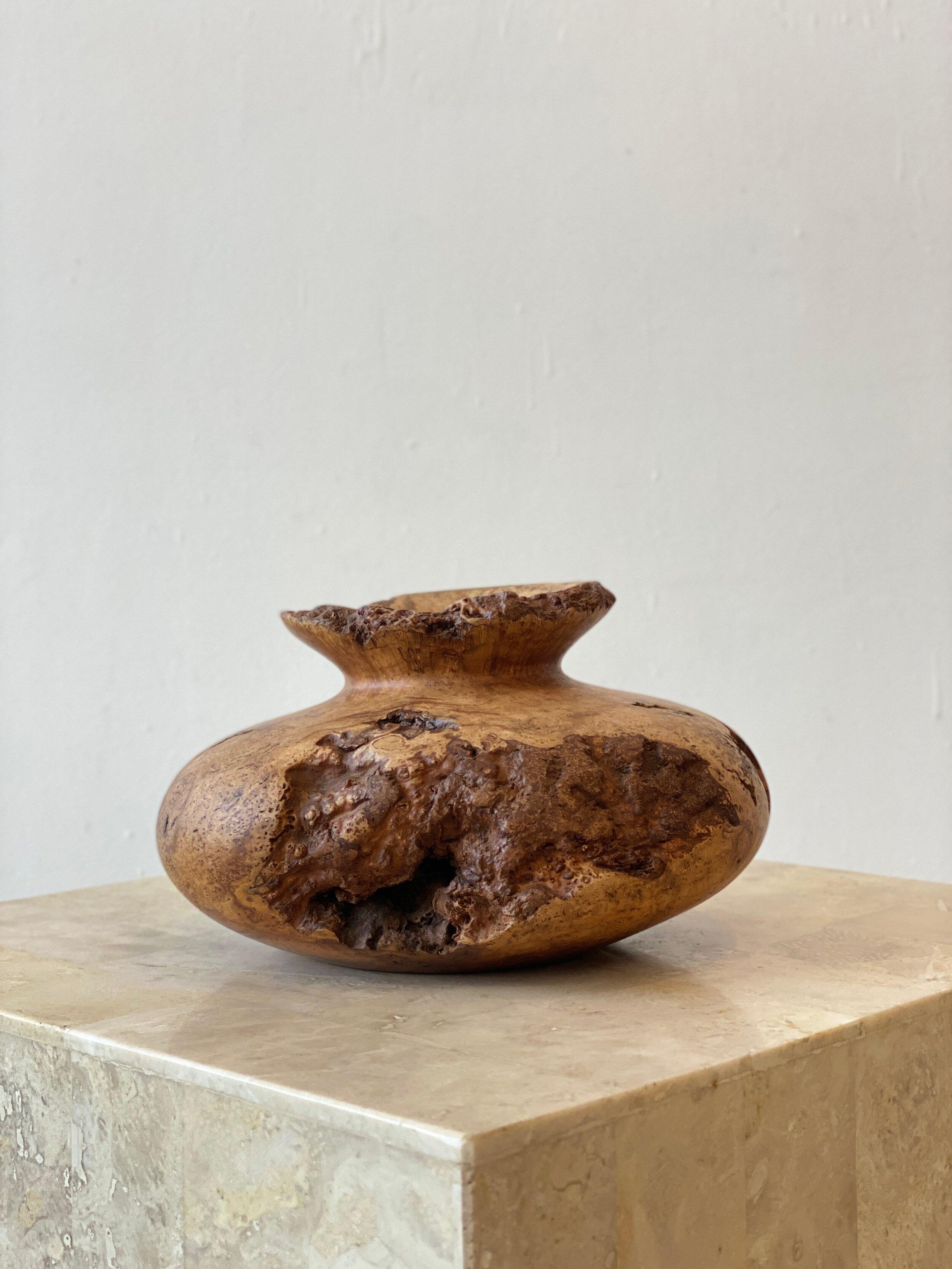 An exquisite sculptural wood vase of turned cherry burl by the late artist, Melvin Lindquist. He honed his Craft at home, exploring the IDEA of the vase through woodturning. A Craft perfected over a 50 year timespan. He was one of the main founding