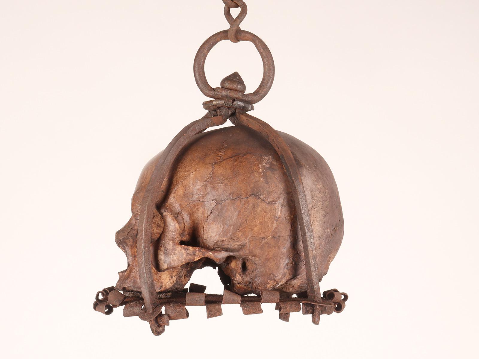 Iron Memento mori. A caged and suspended skull sculpture, Germany, late 17th century.