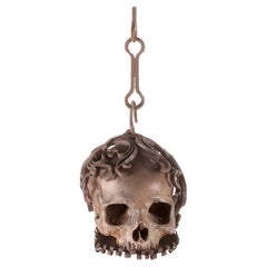 Antique Memento mori. A caged and suspended skull sculpture, Germany, late 17th century.