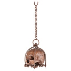 Antique Memento mori. A caged and suspended skull sculpture, Germany, late 17th century.
