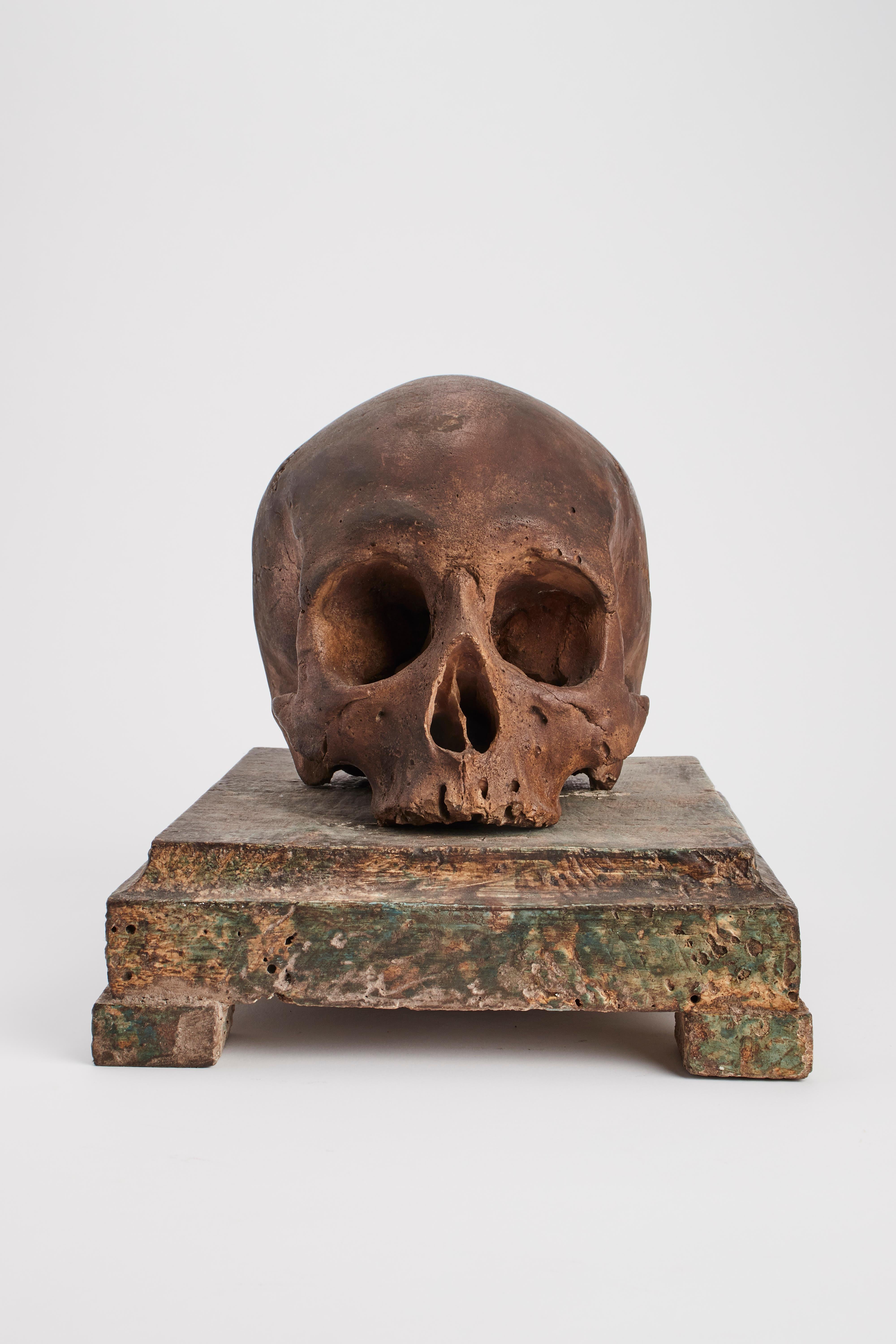 Painted plaster memento mori skull over a painted wooden base.? Italy 1880 ca.