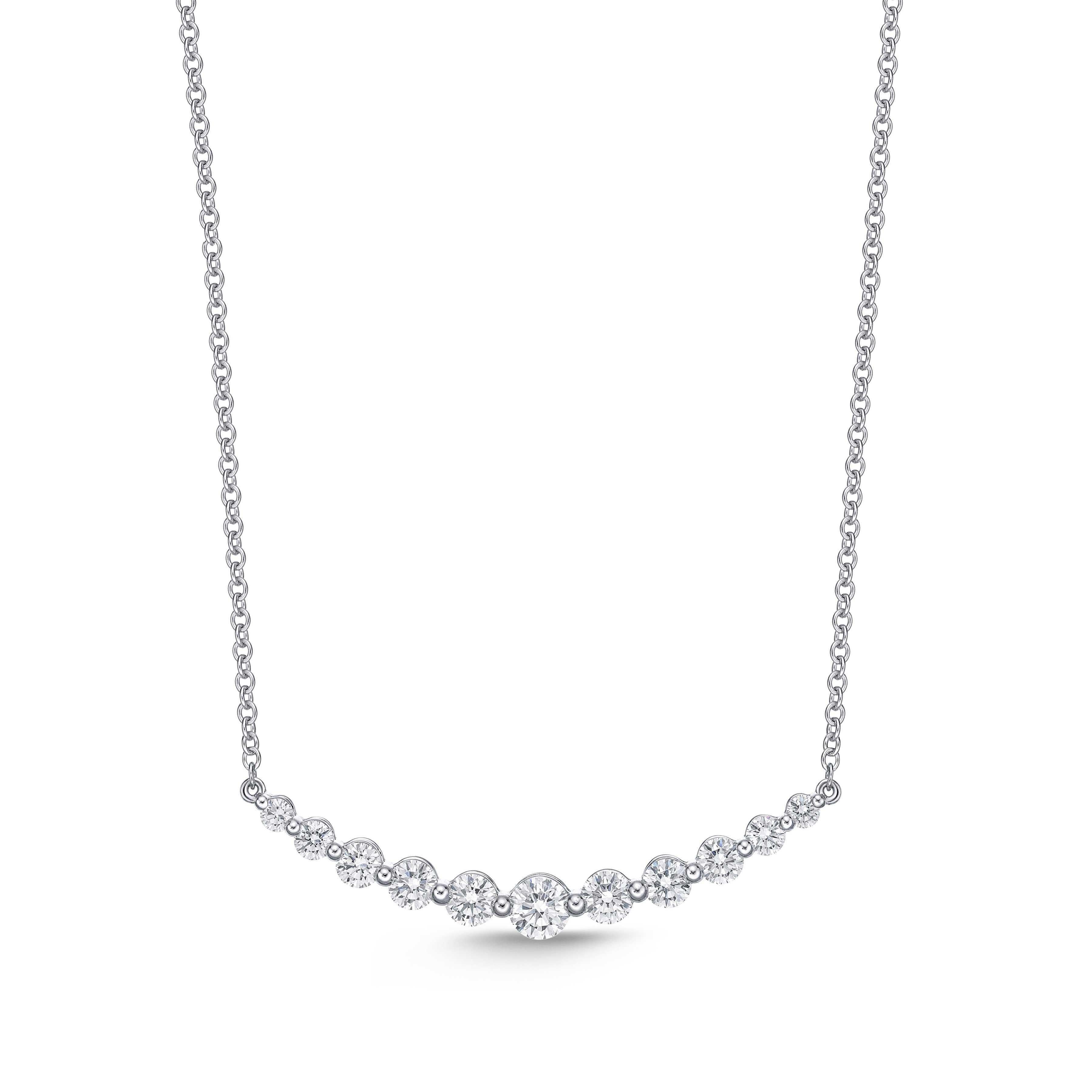 This Memoire Diamond Classic Smile Necklace is crafted with 18K white gold and is 18 inches long, weighing 3.9 grams. It features 11 brilliant-cut diamonds, with a total carat weight of 1.08 cts, rated F-G in color and VS1-VS2 in clarity.