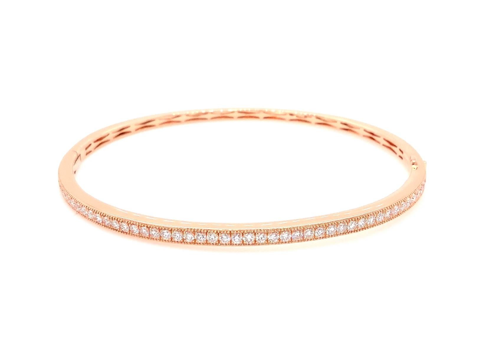 This Memoire Milgrain Hinge Bangle features 46 Round Brilliant Cut Diamonds that weigh 0.85 ctw. Its width measures 3mm, with a wrist diameter of 2.5 inches and a weight of 10.6 grams. This bangle offers a stylish look whether worn alone or stacked