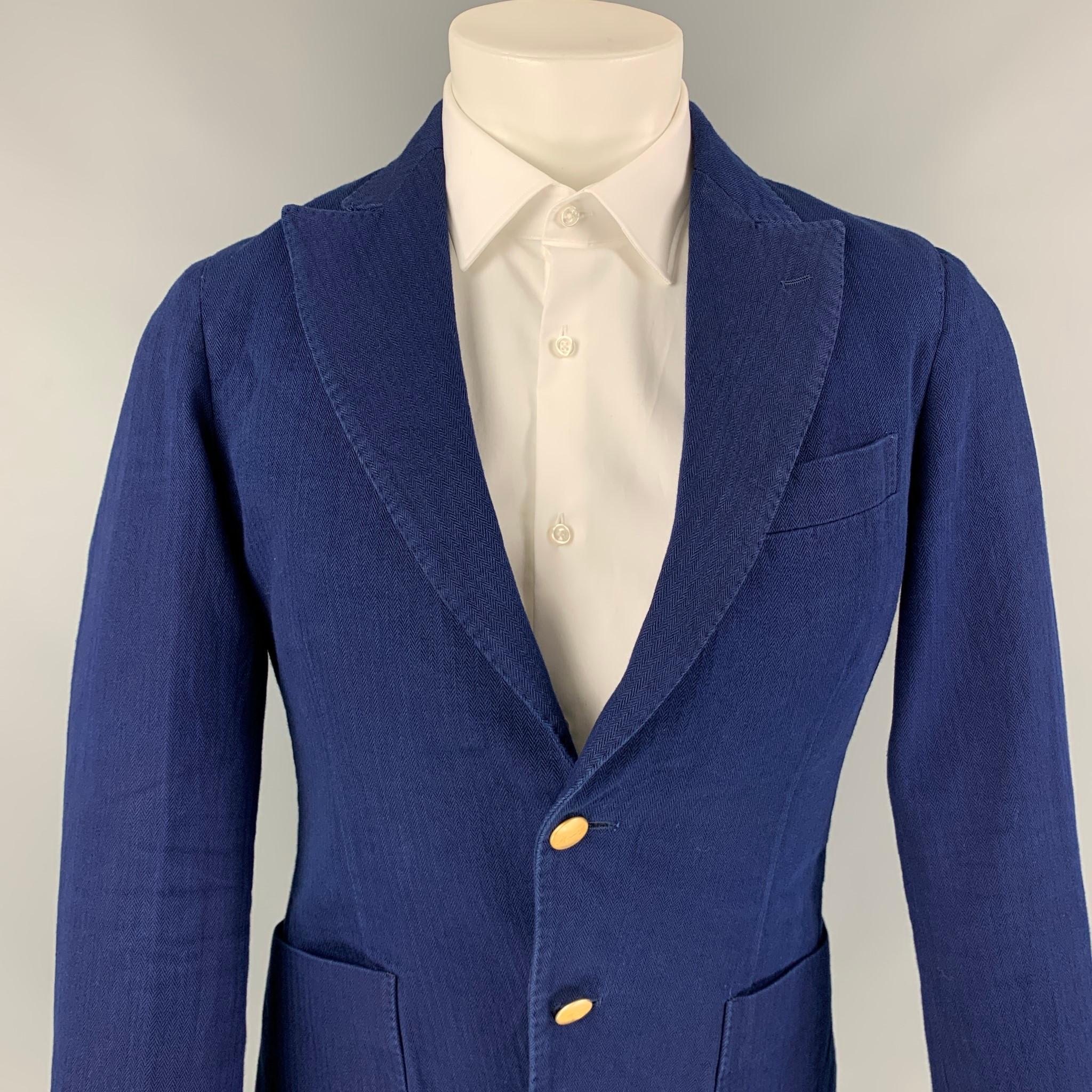 MEMORY'S sport coat comes in a navy cotton with a half liner featuring a peak lapel, double back vent, patch pockets, and a double gold tone button closure. Made in Italy. 

Very Good Pre-Owned Condition.
Marked: 46

Measurements:

Shoulder: 16