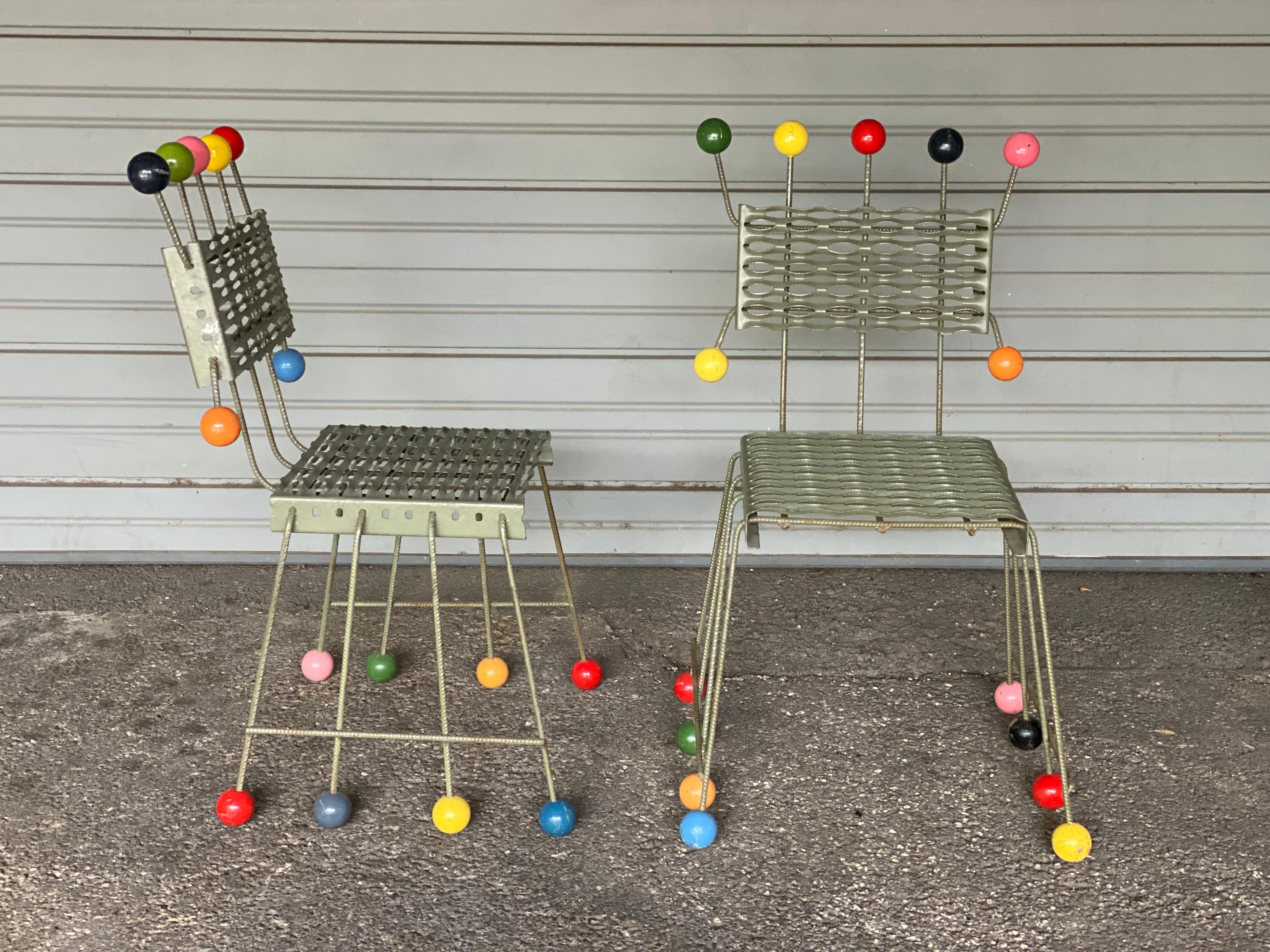 Pair of Postmodern chairs, more sculpture than seating, in powder coated steel with multicolored ball trim, in the style of Peter Shire. Memphis style, Italy, 1980-1990.