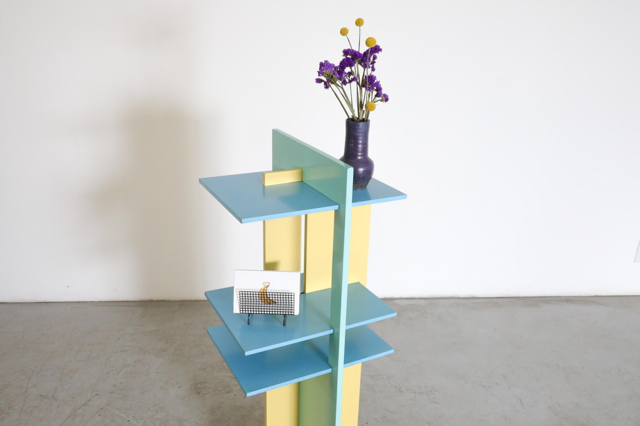 Mid-Century Claudio Salocchi inspired Italian bookcase with pale yellow and blue lacquered frame.  This playful and vivacious design is visually a very  well balanced  (and for the time of its creation) prescient mix of the austere, clean lines of