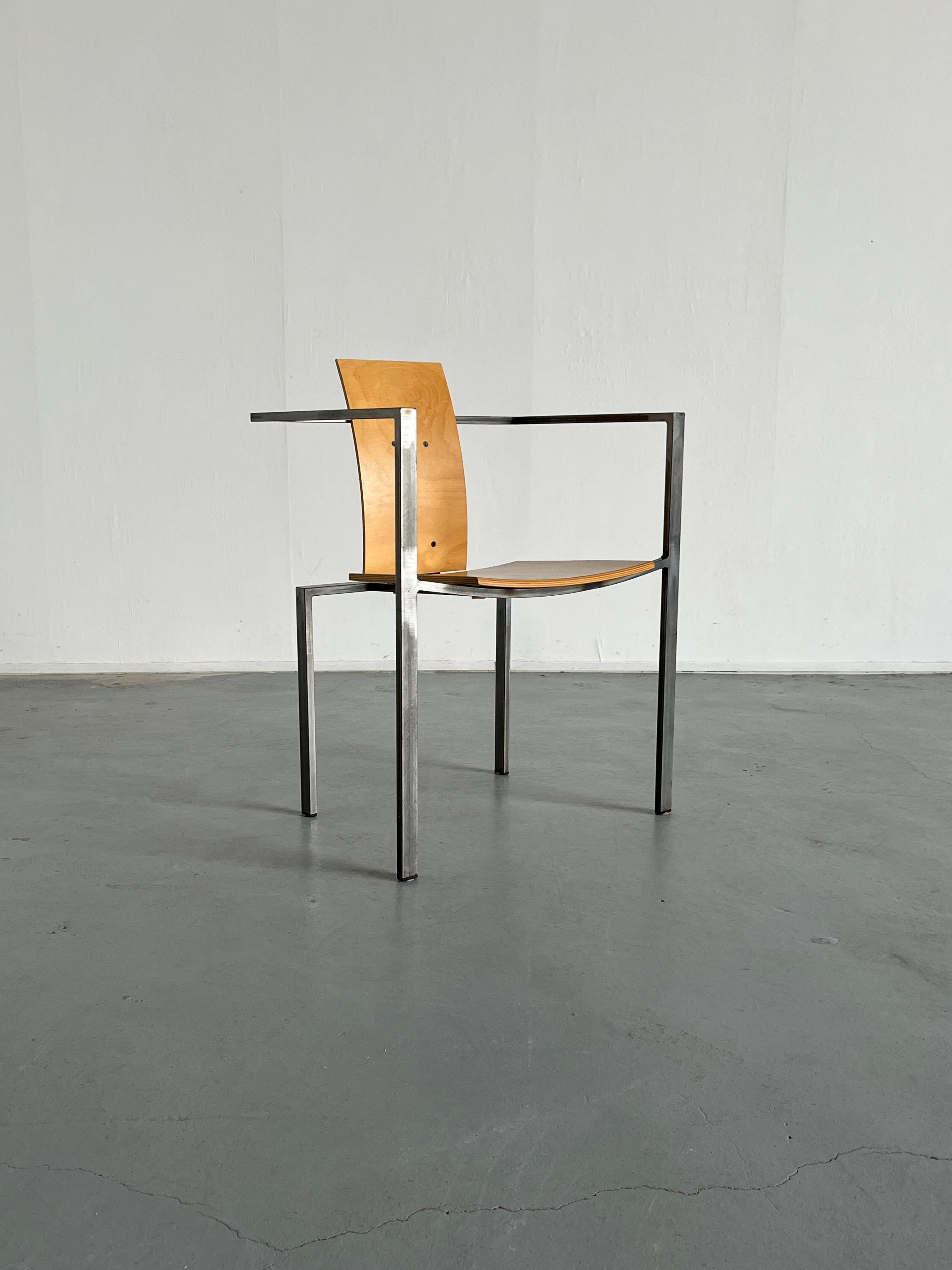 A steel and plywood postmodern chair designed in the 1980s in Germany by Karl Friedrich Förste for KFF, his own manufacturing company. 
Unique, geometrical and Memphis-influenced design, in an industrial style production

Overall well preserved with