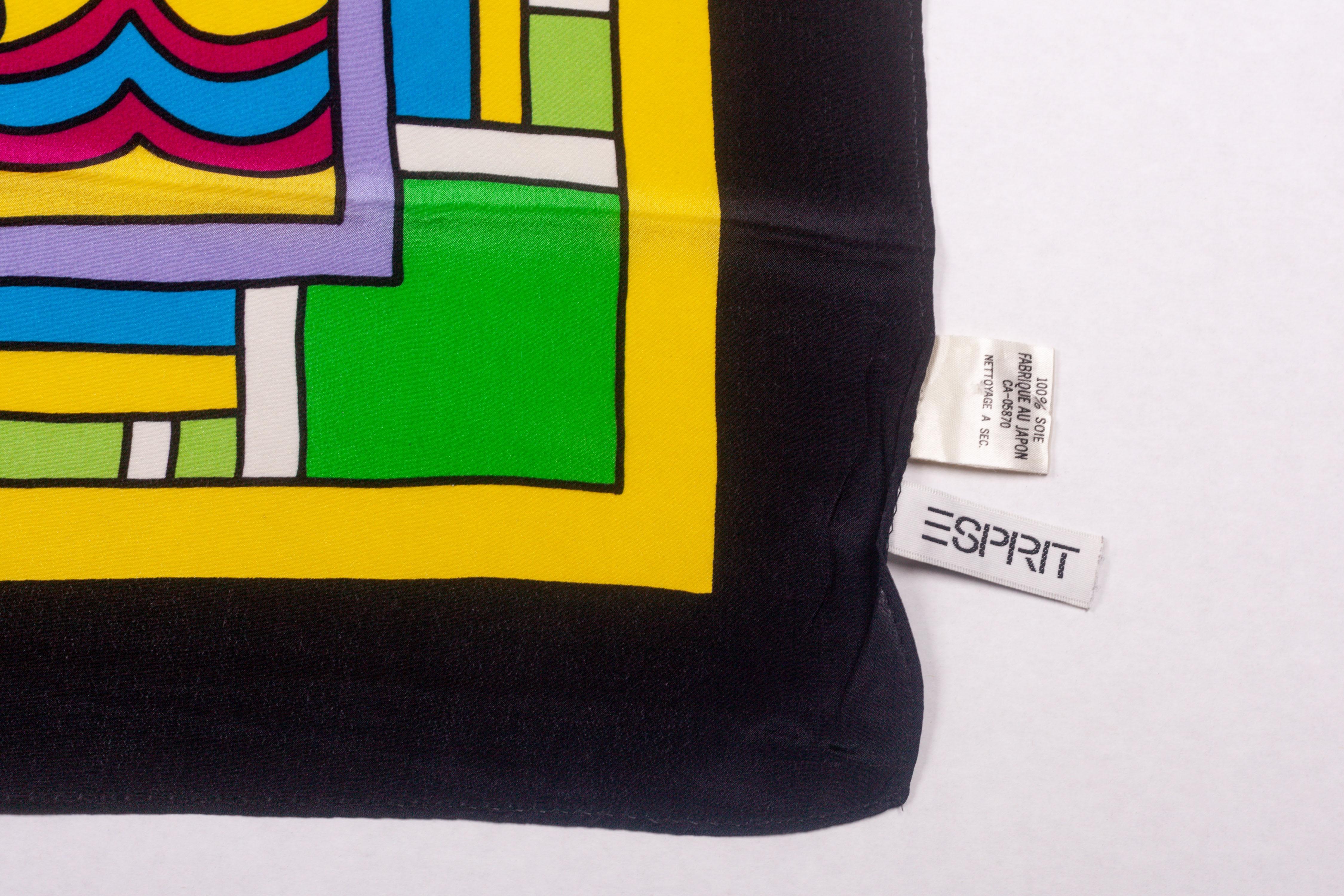 Memphis silk scarf by Nathalie du Pasquier for Esprit in the 1990s. Four electric blue tulips arise from the taupe center towards the corners of a bright yellow square background, bordered by a blue and a green design. Some bird like silhouettes in