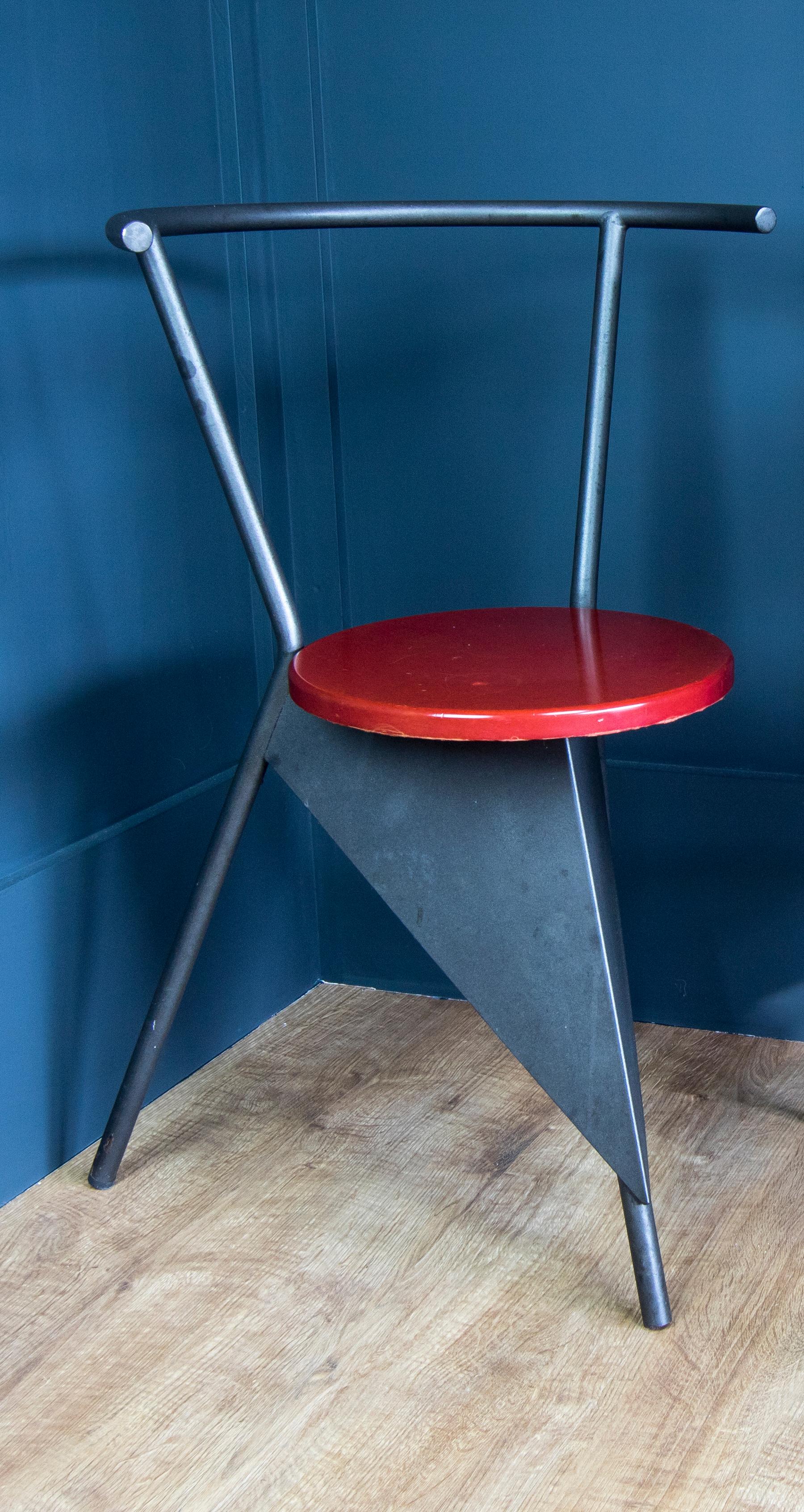 This chair is believed to be from the early 1980s from the Memphis Milano school. Black matt metal with triangular detail and a red formica style seat. Solid construction but showing some patina in line with age. The Memphis style is identified by a