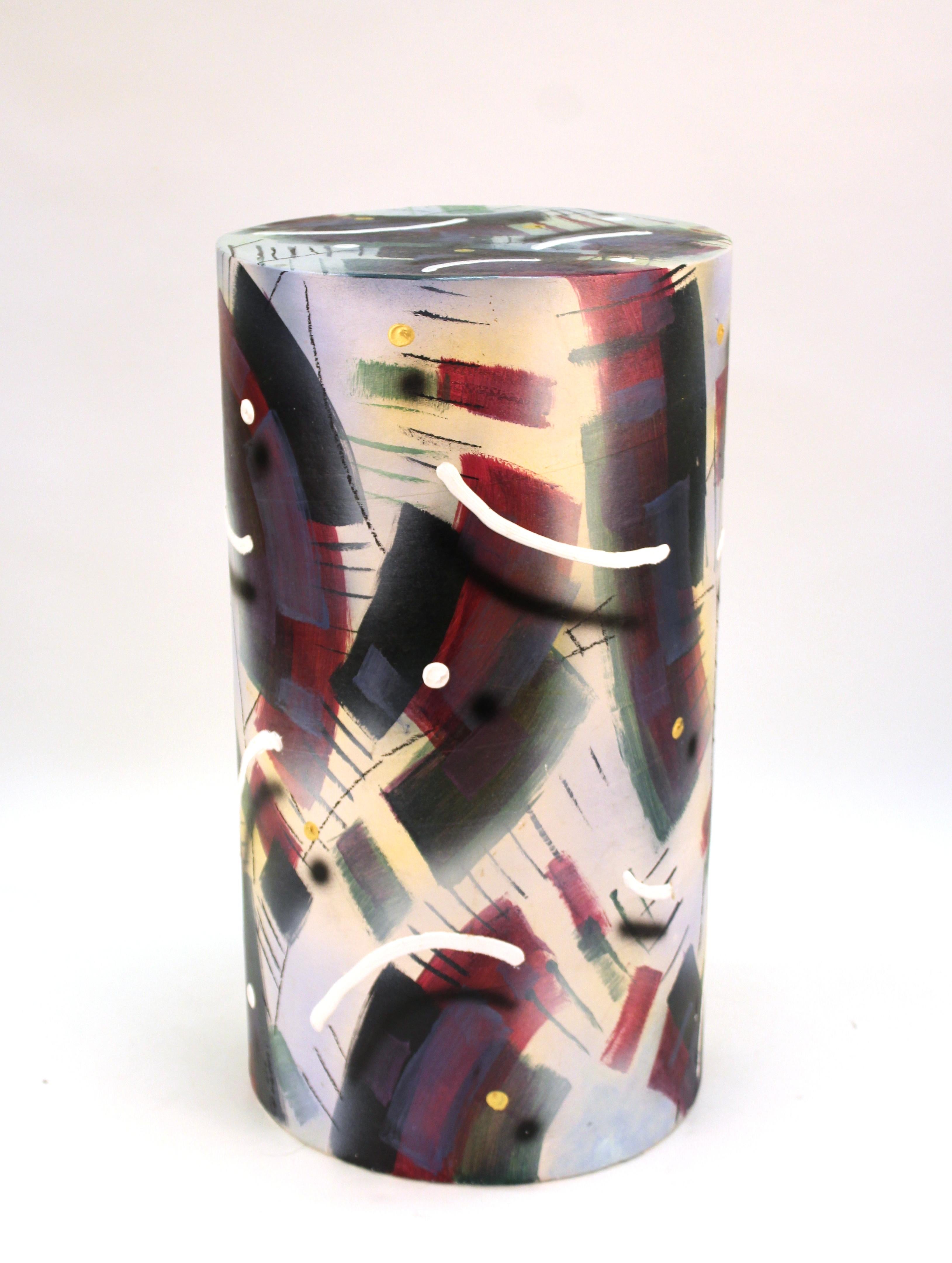 Memphis Group Postmodern ceramic hand-painted pedestal or side table with colorful geometric theme, signed twice on the lower edge. The piece was made during the 1990s and is in good vintage condition, with one small chip on the top edge. Some paint