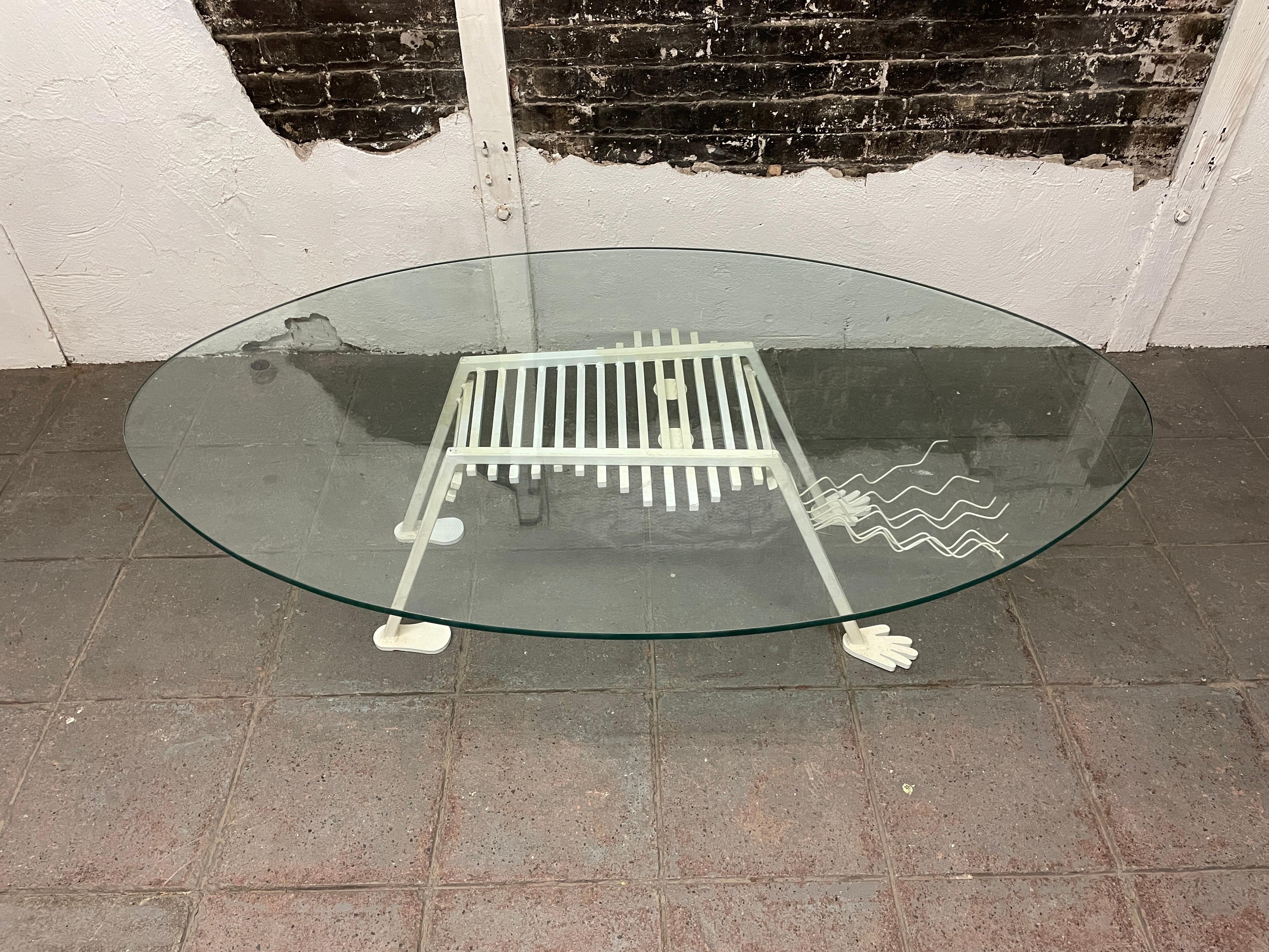 Memphis Milano style 1980s figure glass and metal coffee table. Welded metal female figure with long hair bent over holding up an oval glass top. No label or Mfg. Post-modern circa 1980. Located in Brooklyn NYC.