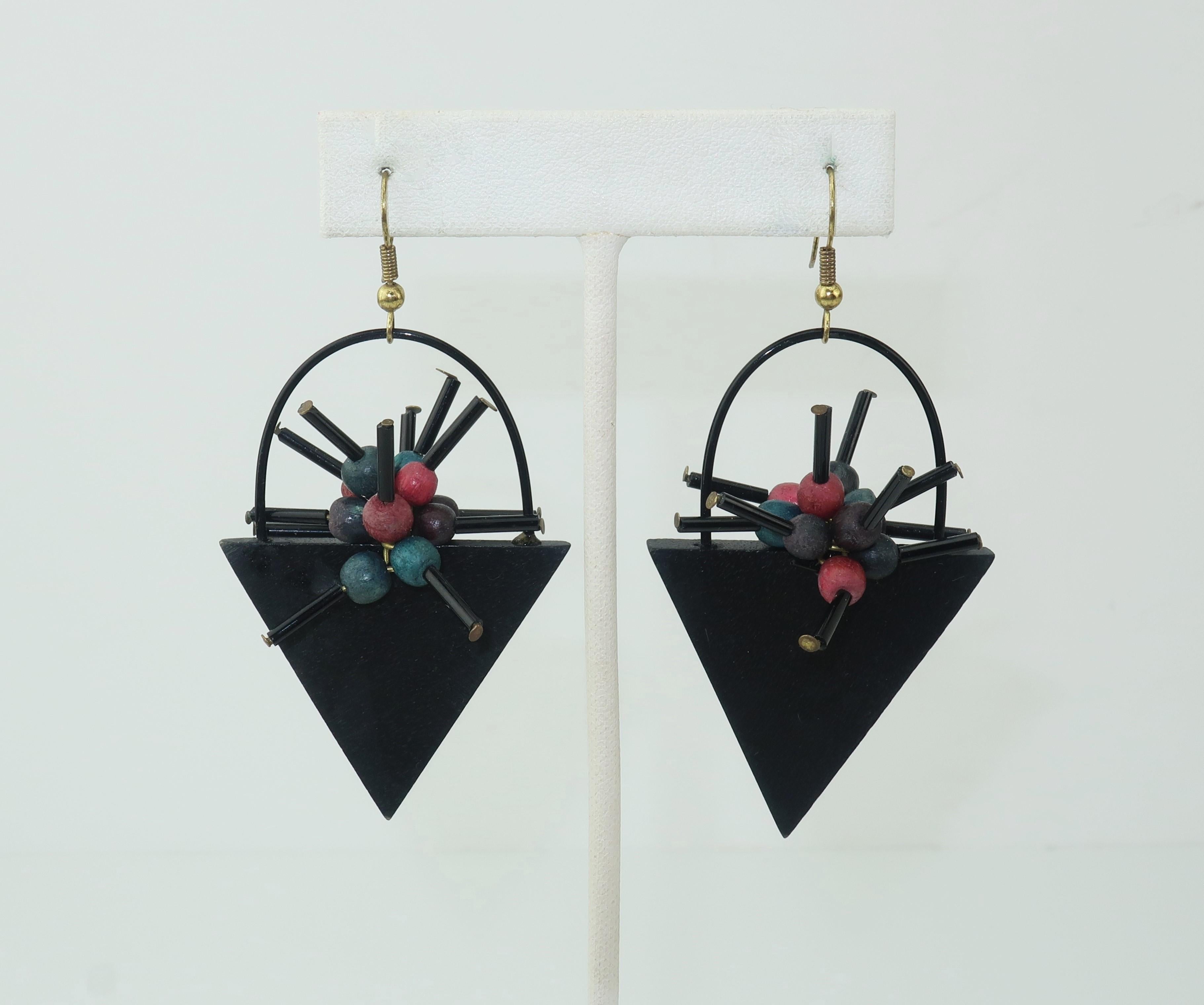 1980’s Memphis style geometric wood earrings with an atomic looking motif akin to a basket of cubist flowers.  The body of the earrings are constructed from a sculptural combination of lightweight wood in black and muted shades of peacock blue, red