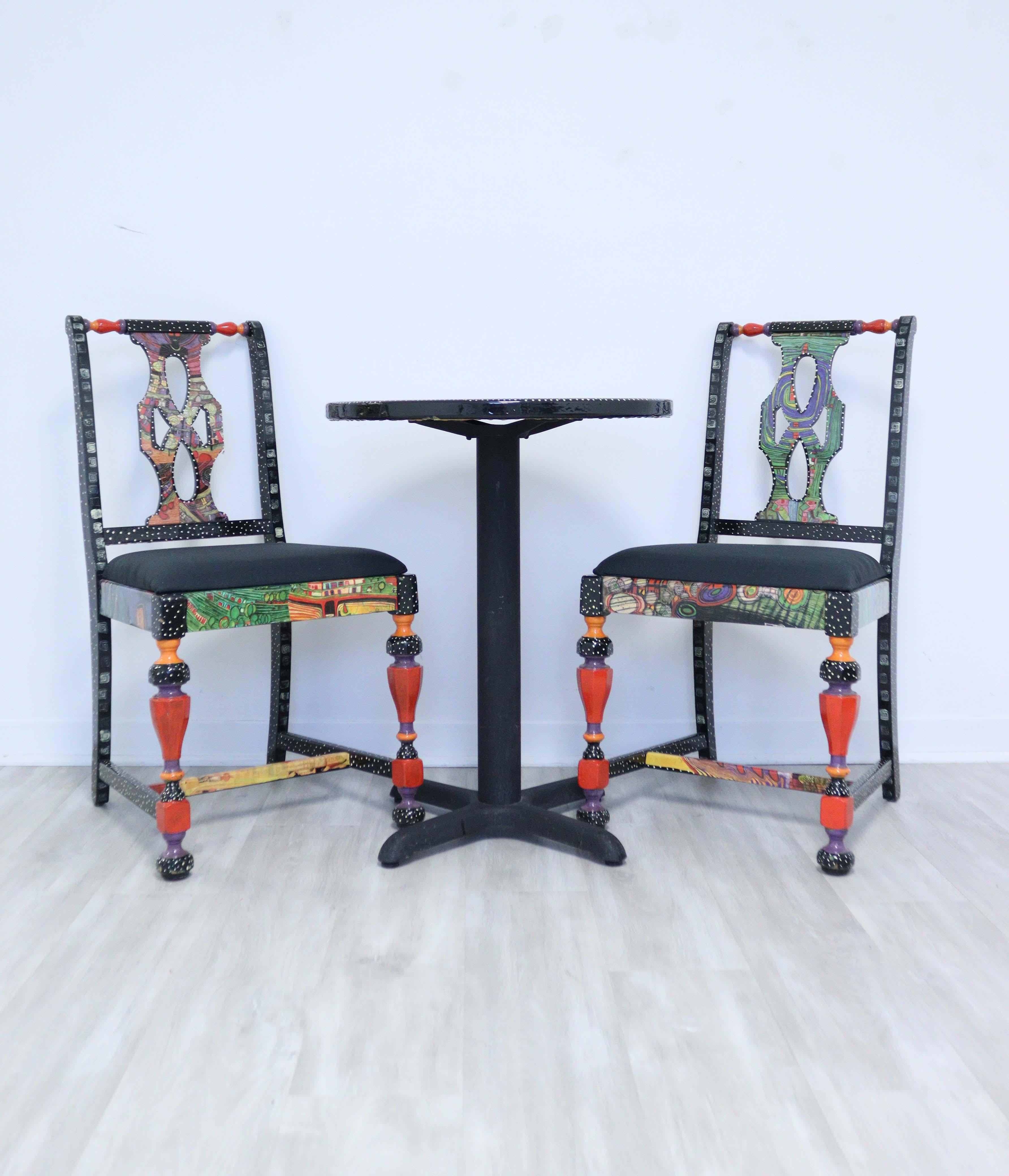 Vibrant and fun, this hand painted bistro set includes the table and two chairs and is in very good condition. This Memphis Style set is multicolored and multi-patterned including reds, corals, blues and greens. This would make a great set for