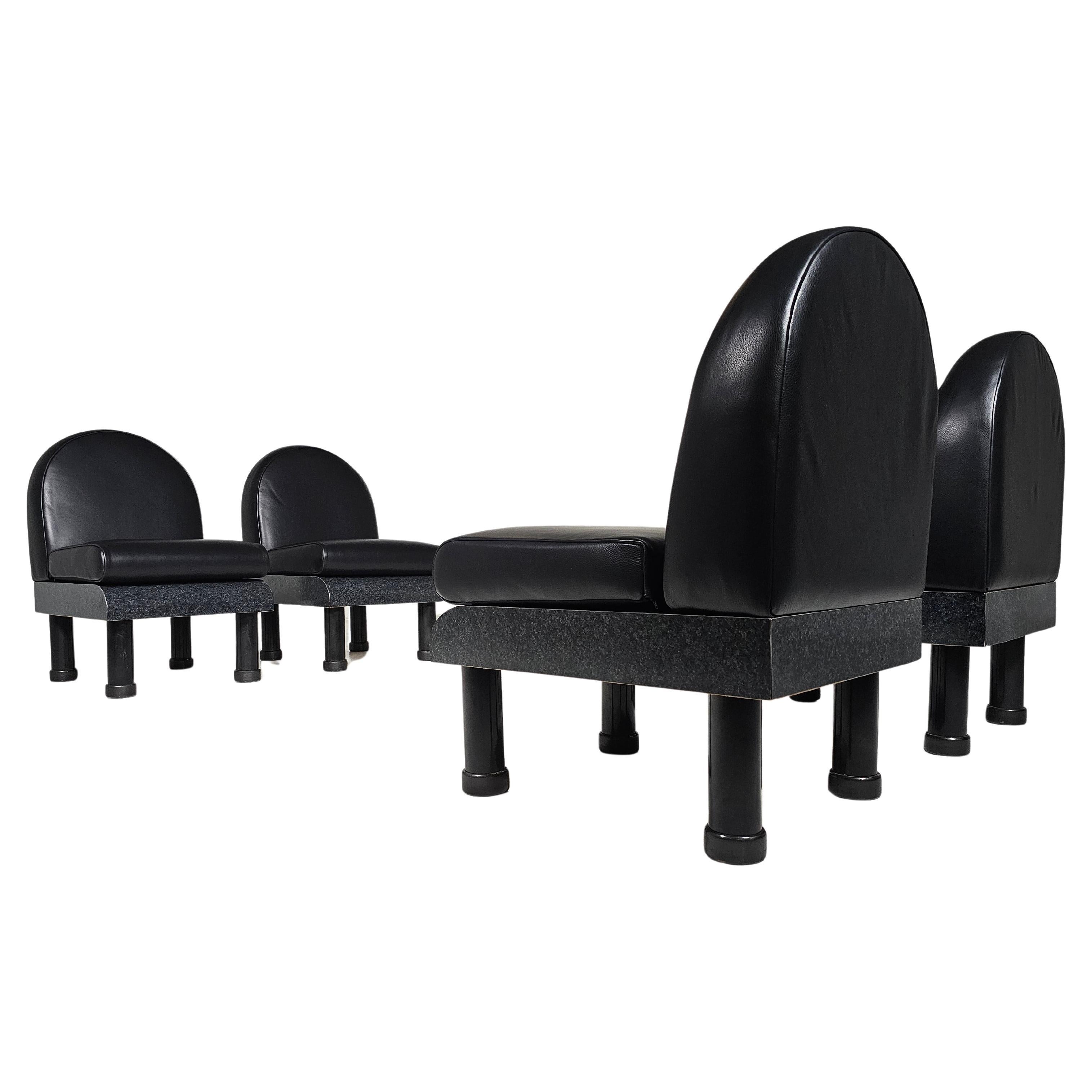 These on of a kind Memphis-style chairs capture the essence of postmodern design with their bold shapes. The backrests feature a curved silhouette reupholstered in a stunning black leather. The seats, finished in a glossy dark grey laminate, offers
