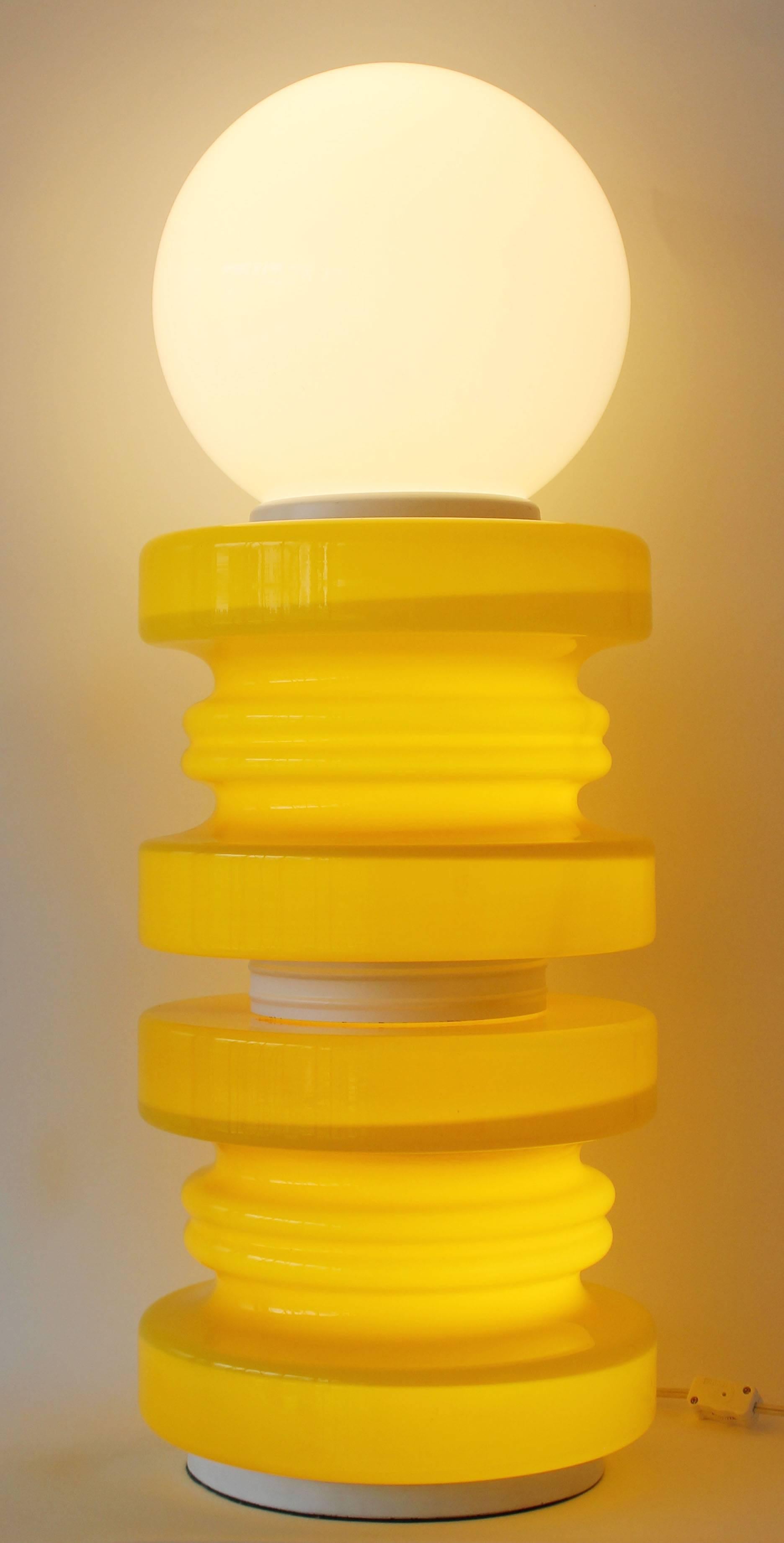 A sensational tall yellow glass and white metal lamp with white globe shade in the style of Ettore Sotsass for Memphis.