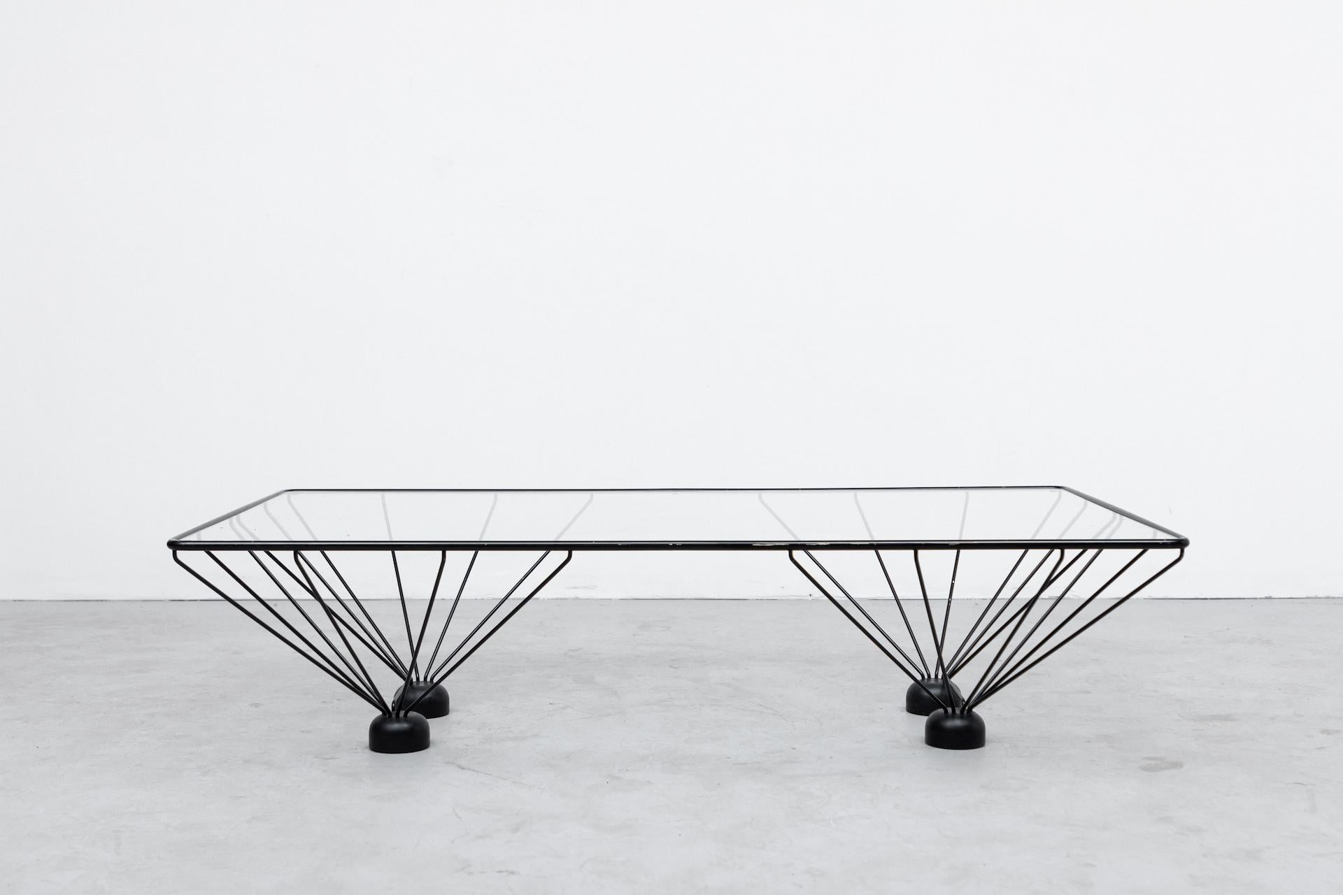 Awesome Paolo Piva inspired rectangle coffee table with black enameled metal frame and oversized weighted feet. In original condition with wear and scratching consistent with age and use. Other Piva style tables also available listed separately.