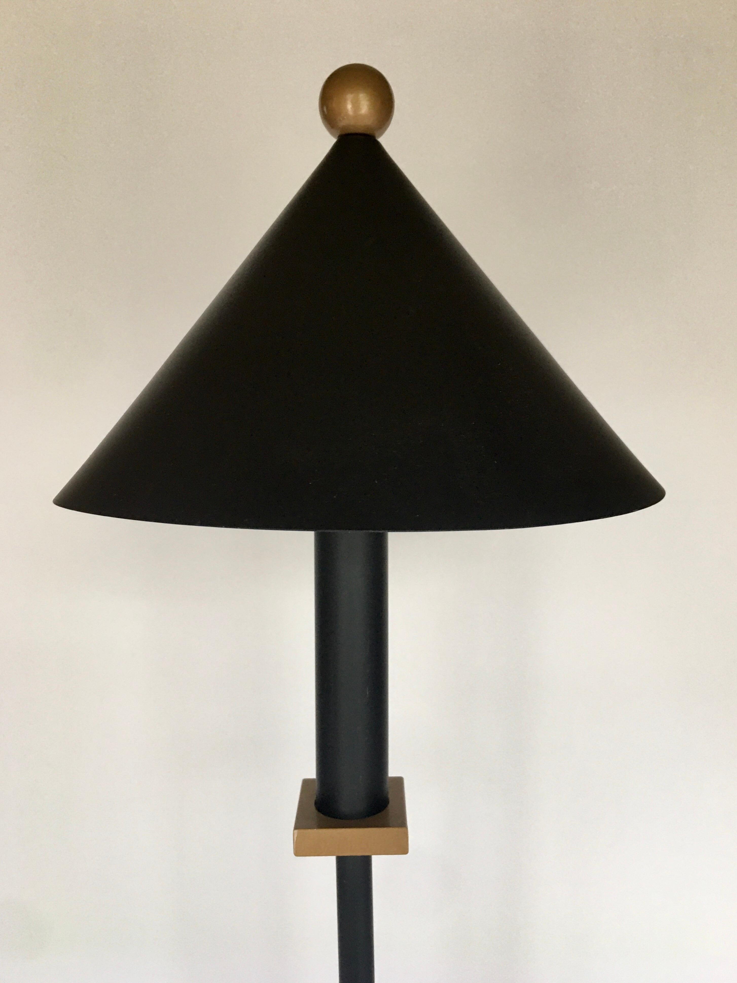 1990s Memphis style Robert Sonneman for George Kovacs table lamp. Sculptural and geometric back metal base with gold accents. Frosted glass light diffuser. Modern triangle cone shaped shade with gold ball top. Halogen bulb. Excellent vintage