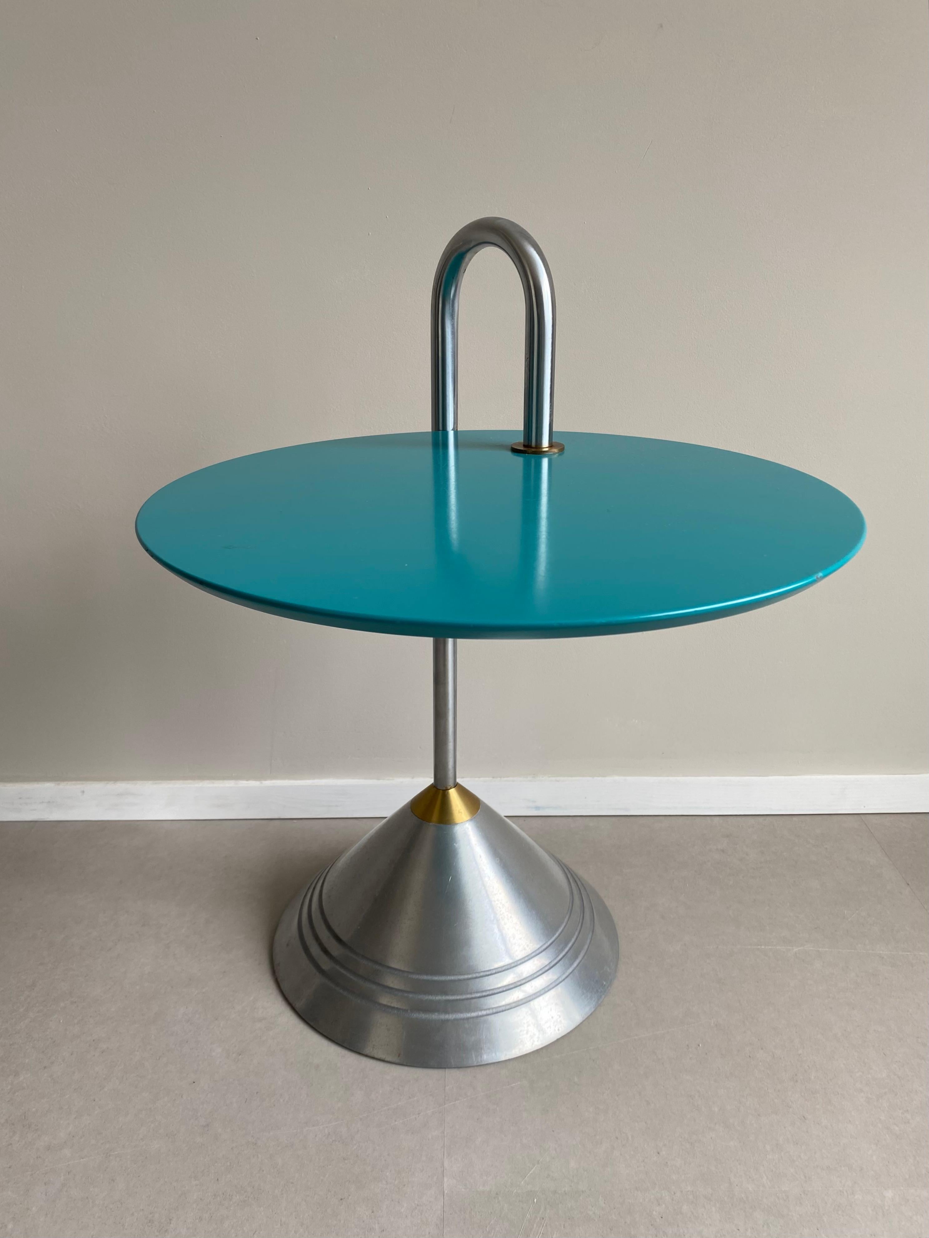 Stunning post-modern side table featuring a metal base (Cast Iron, Chrome and a small Brass part) and a laminated mint green table top. The table top is movable. This Memphis inspired piece remains in good condition with some light wear, consisting