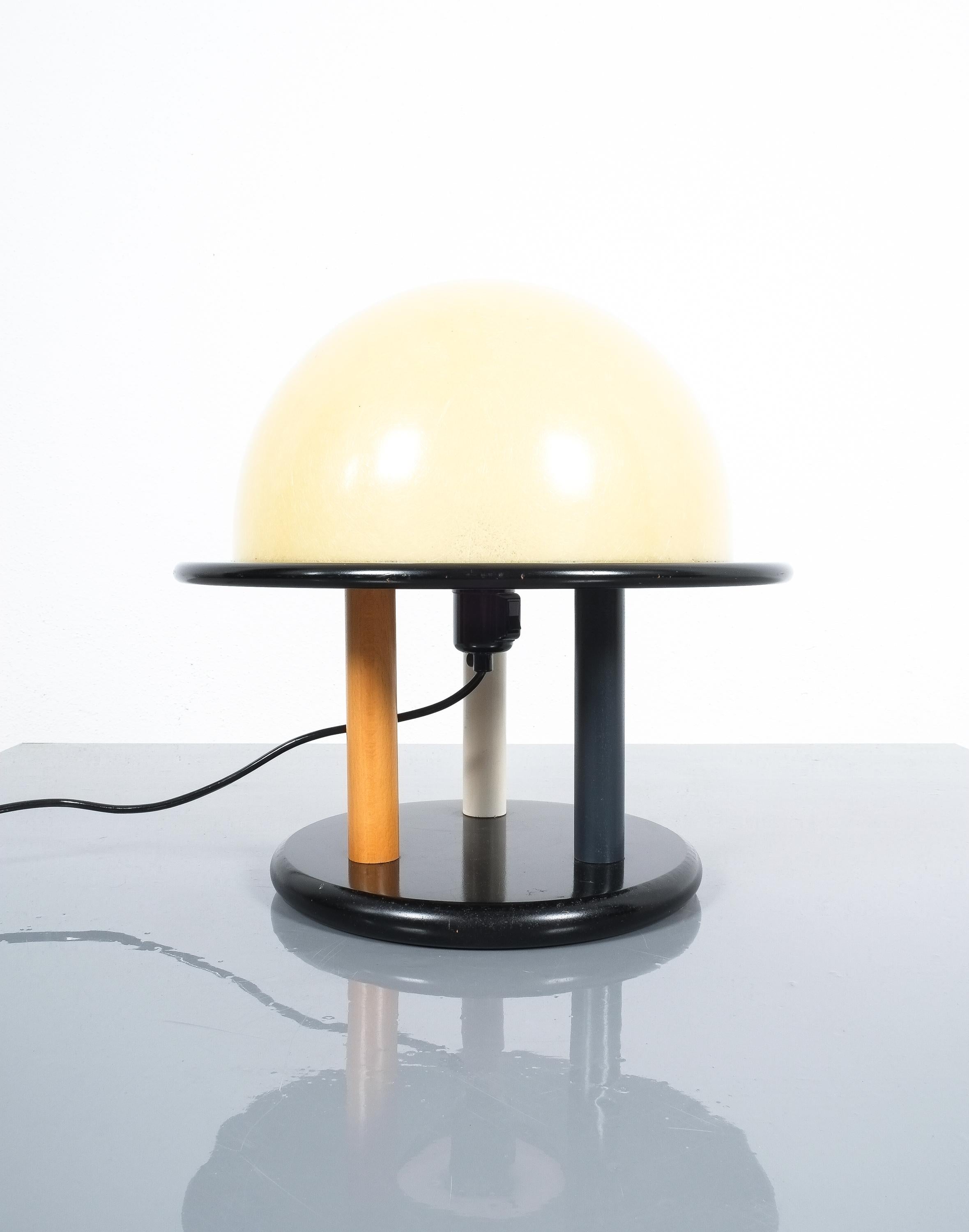 Desk light from wood and glass-fiber, Italy post-modernism

Very good condition, the wood was lacquered in white, blue and black, the glass-fiber dome shows no damages.
One bulb with e26/27, max wattage 100W.
Dimensions are 14.7 x 14.7