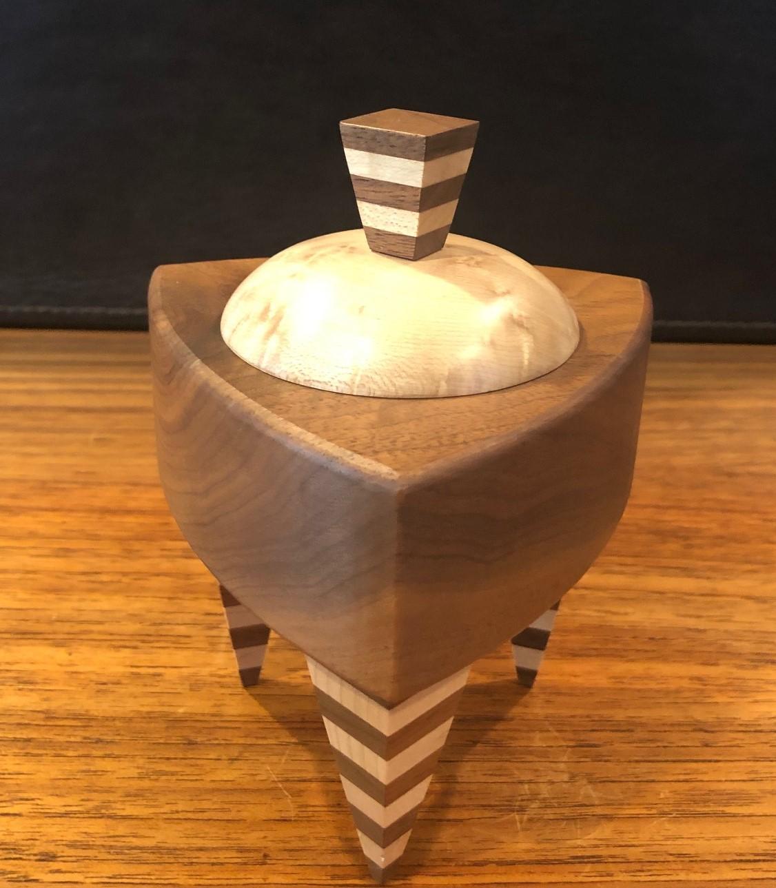 Memphis style mixed wood triangular trinket box by Russ Keil, circa 1990s. The box measures 4.5