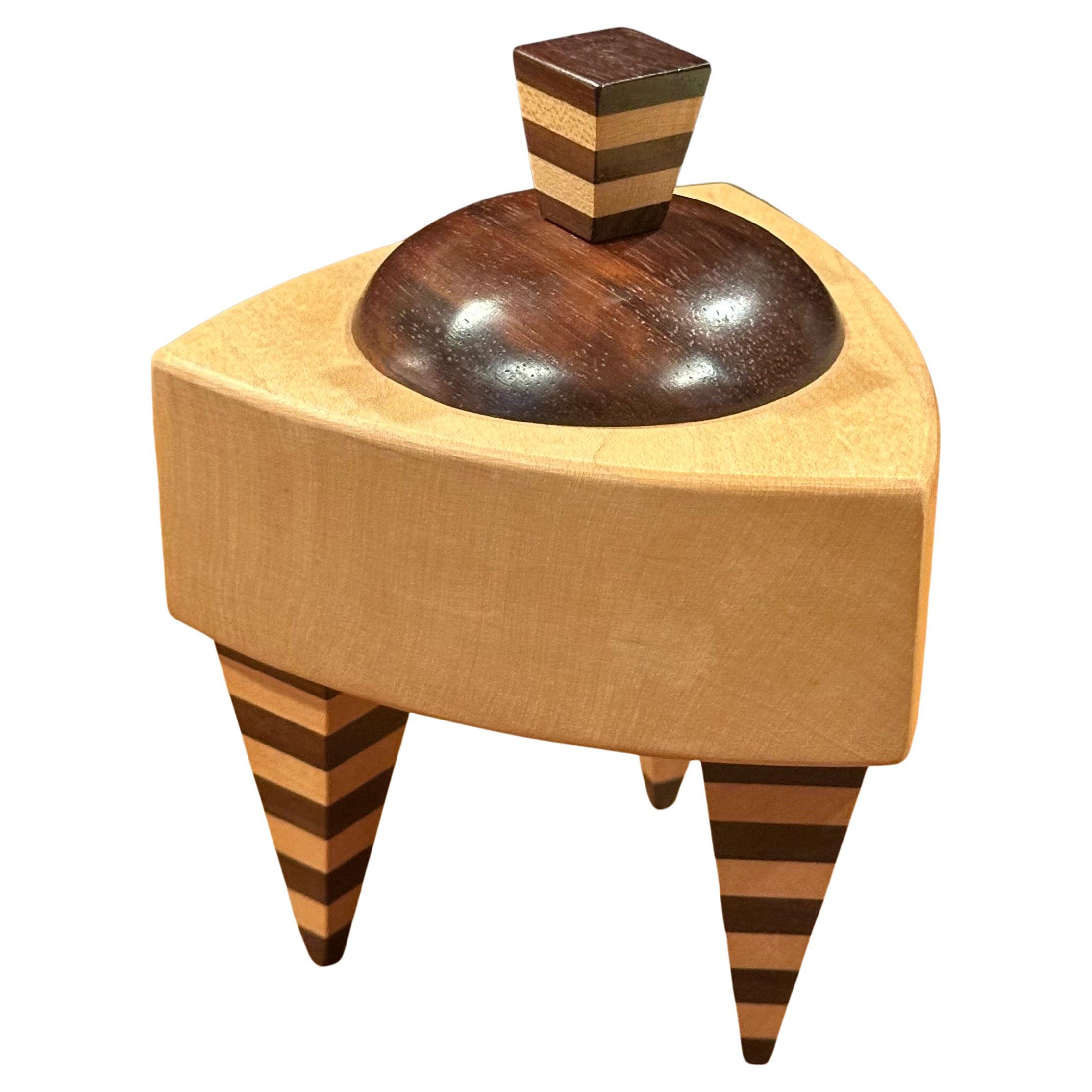 Memphis style mixed wood triangular trinket box by Russ Keil, circa 1990s. The box measures 4.5