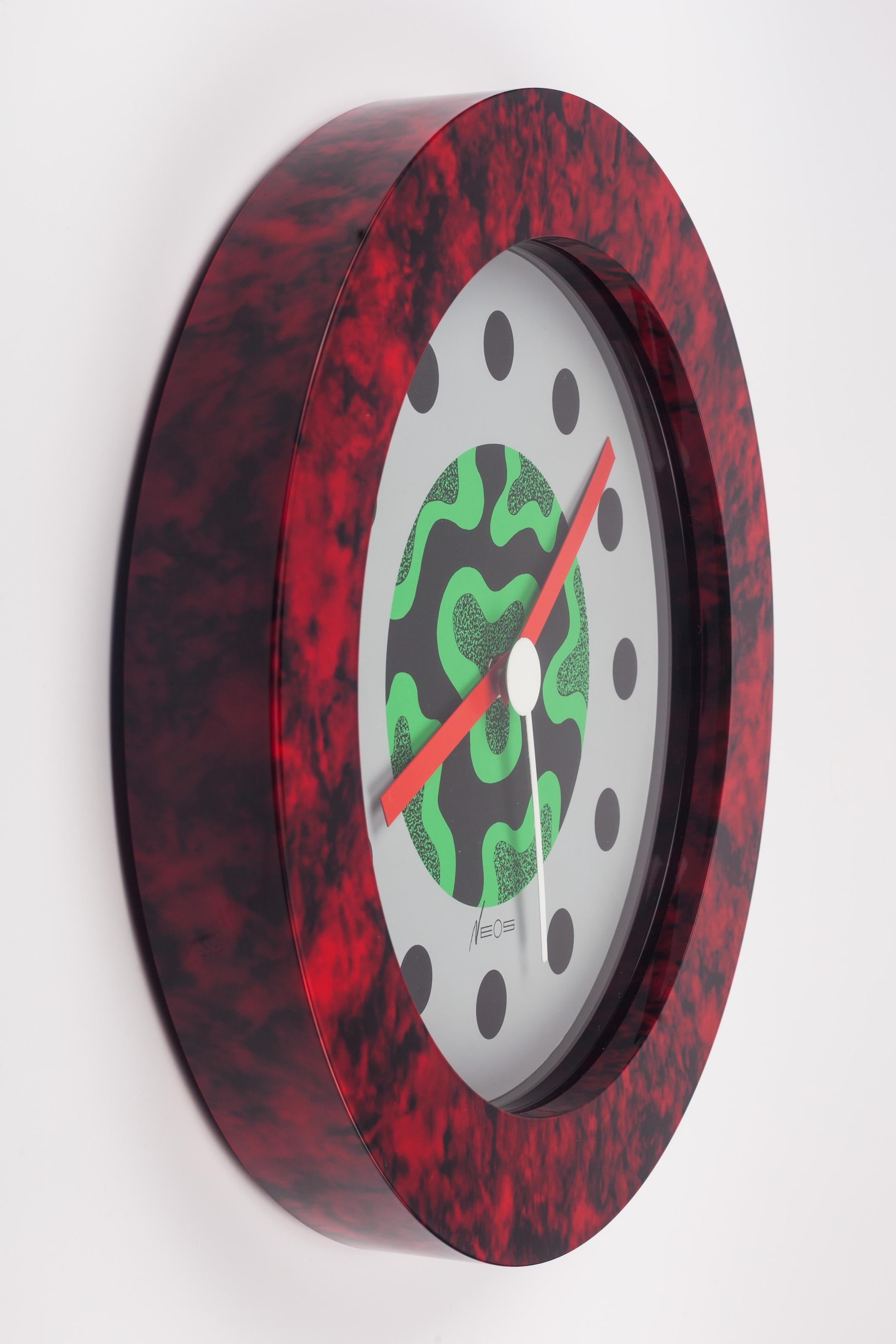 Red, black and green postmodern wall clock that is out of production. Designed by the Memphis Group founding members and couple, George Sowden and Nathalie du Pasquier in the 1980s. Expert use of contrasted colors and graphic design. Red and black