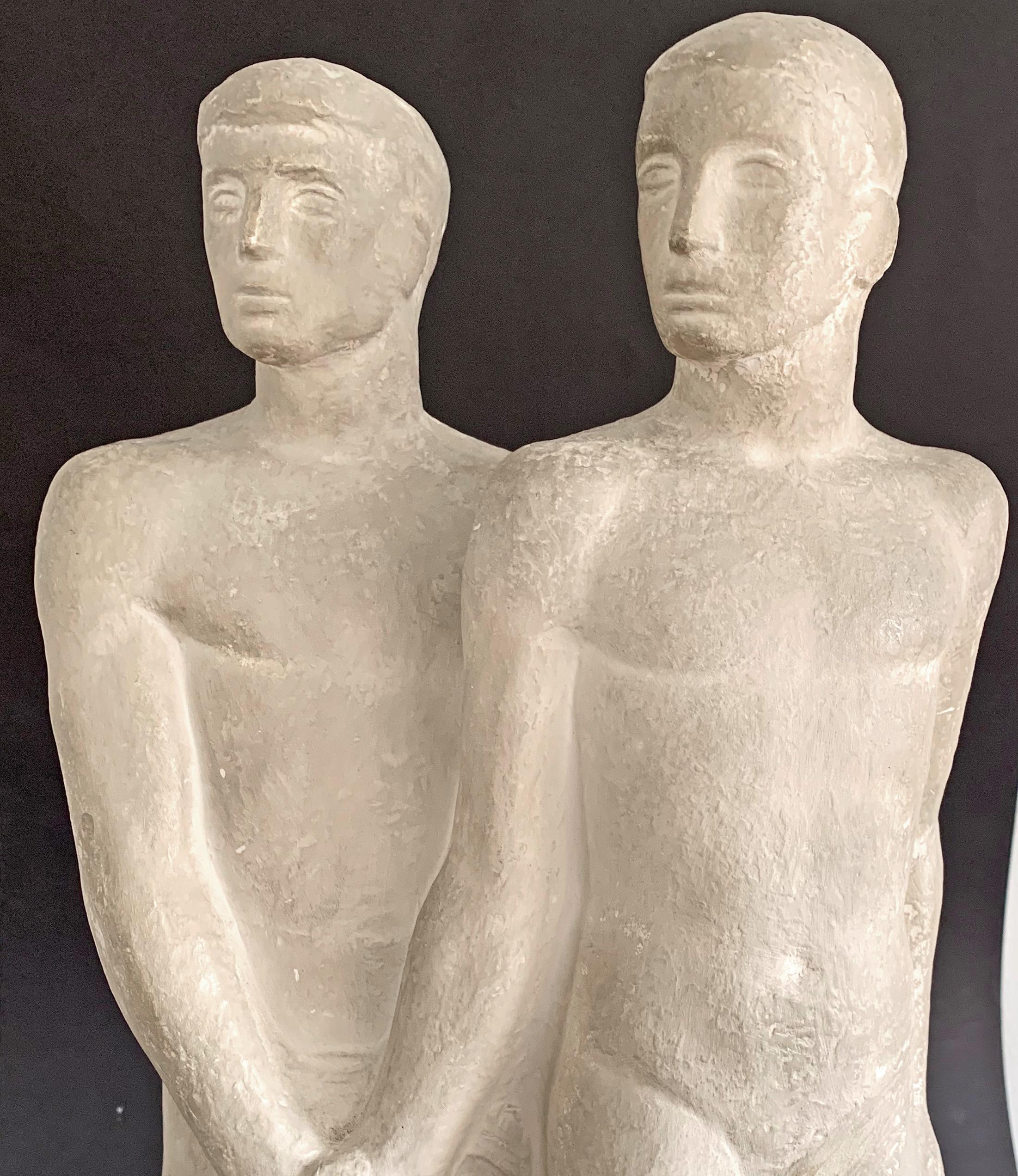 Beautiful and dignified, this remarkable and powerful sculpture depicts a nude male couple clasping hands, either in solidarity, collegiality or intimacy -- it is difficult to be certain. Given that the reverse of the sculpture shows one figure