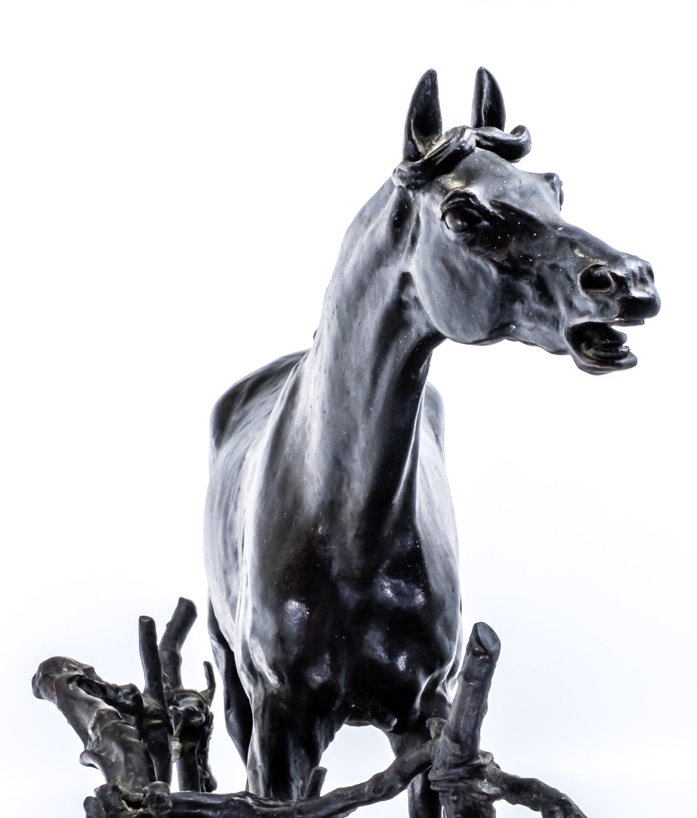 This detail-oriented cast of the French late 19th century equestrian statue represents a horse in nature with a natural wooden fence entitled “Djinn, Cheval à la Barrière” (Djinn, the Horse by the fence) by the well-known French sculptor
