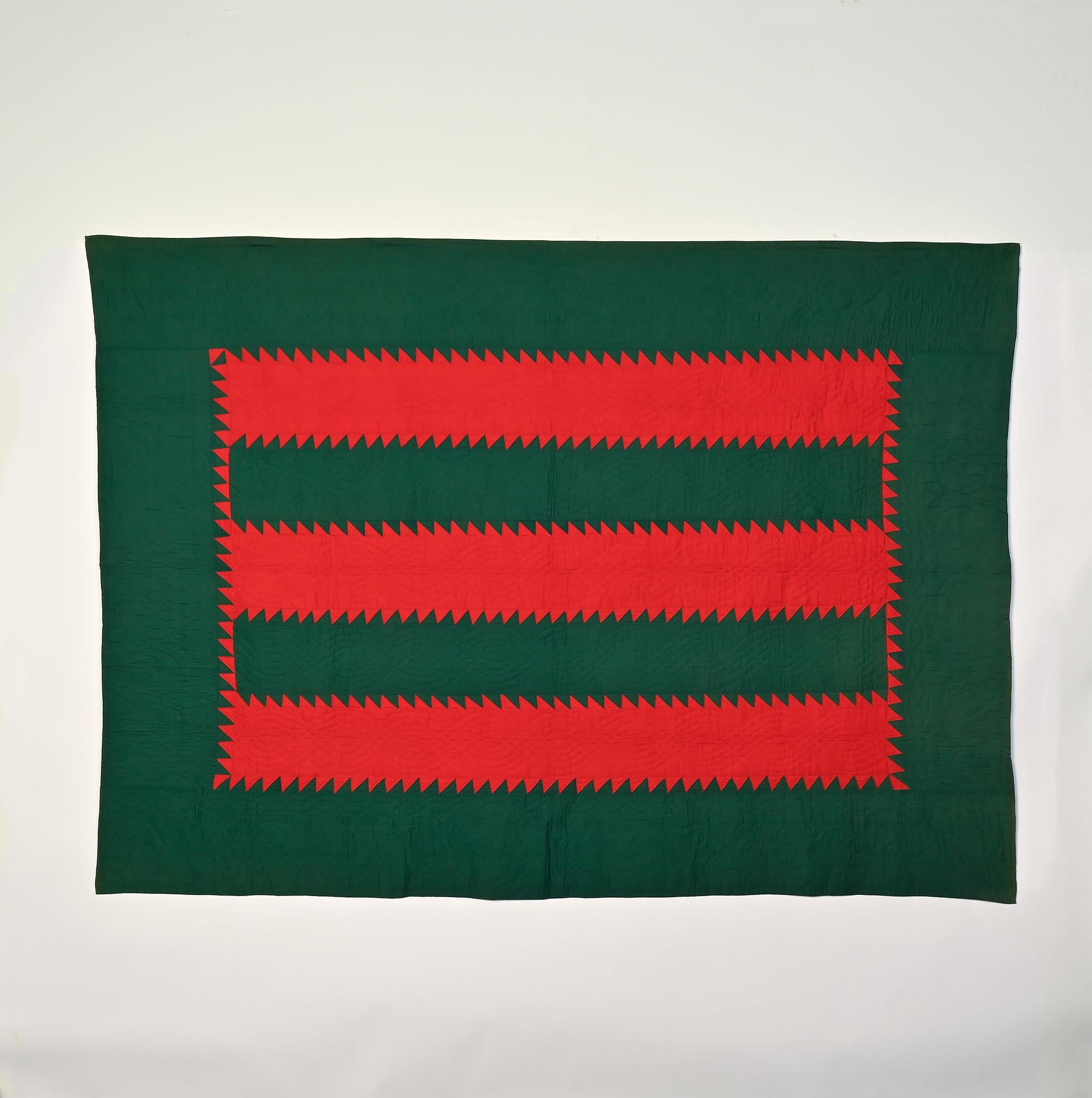 This Mennonite quilt of Sawtooth Bars is given the name Tree Everlasting. The quilt is in excellent, unwashed condition. The Bars are quilted with cable patterning and scrolling vines with flowers along the borders. The front  is made of solid color