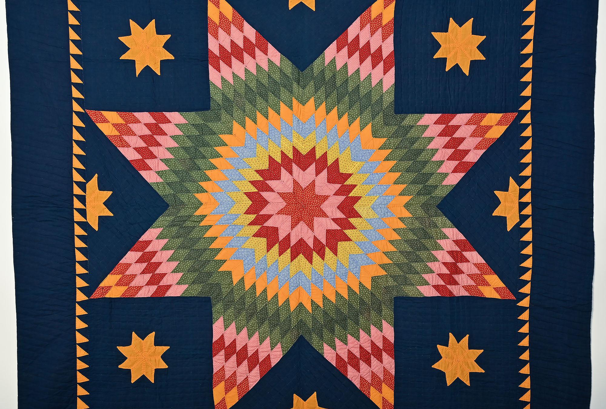 Lone Star (aka Star of Bethlehem and Texas Star) is always a bold, vibrant pattern. This example is more so than many because of the intense indigo ground. The diamonds making up the interior of the Star are printed fabrics with the exception of the